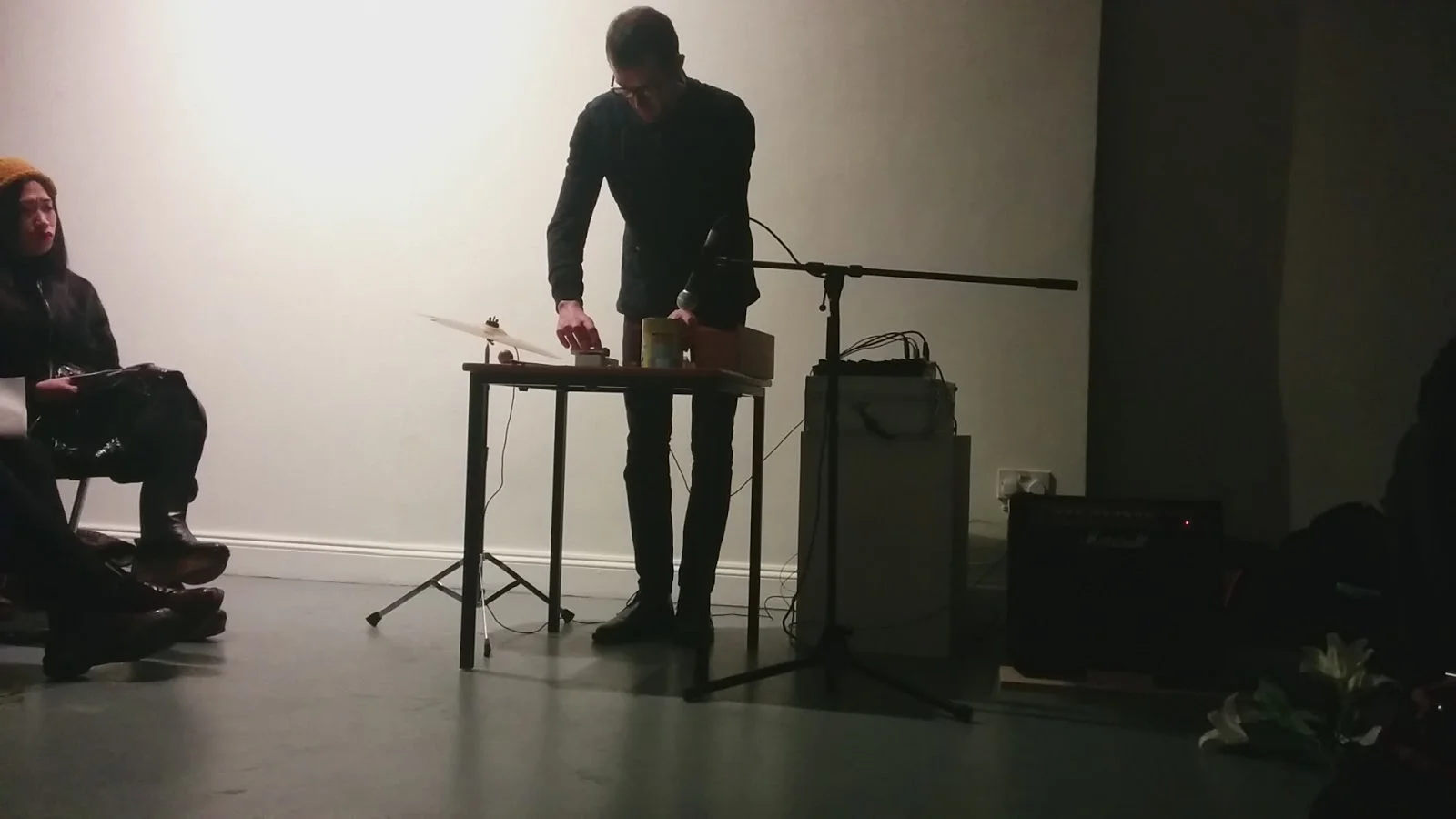 Performing Approaching The Object at Constantly Evolving But Never Ending, Angus-Hughes Gallery, London 2015 using cocoa tin, metal ruler amplified table top, glass jar, cymbal and various found and collected objects.