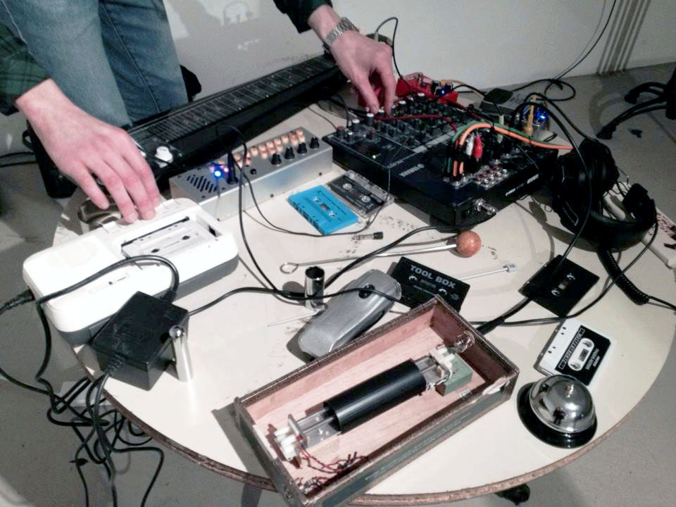  Islington Mill, Salford, 2013.  For “Xmas At The Mill”. Tape recorder, cassettes, reverb spring, lap steel guitar, digital synthesizer, and wind-up torch. 