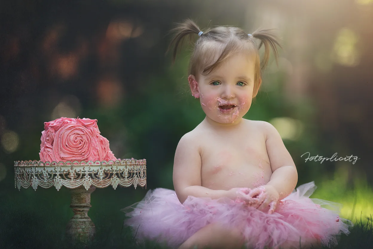 A toddler getting ready to smash her cake