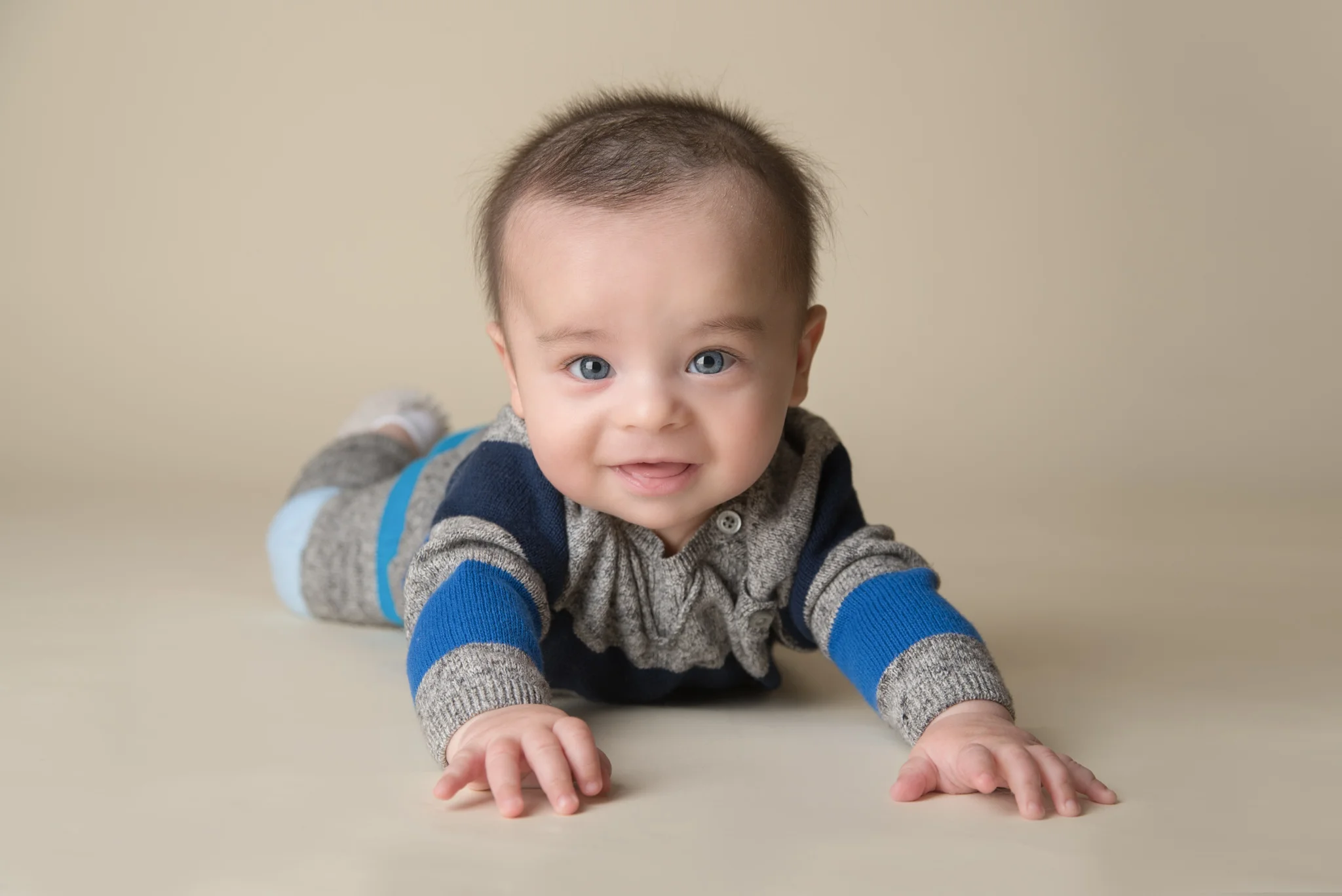 Smiling baby boy during 6-month tummy time milestone portrait — Fotoplicity studio photography, East Brunswick, NJ
