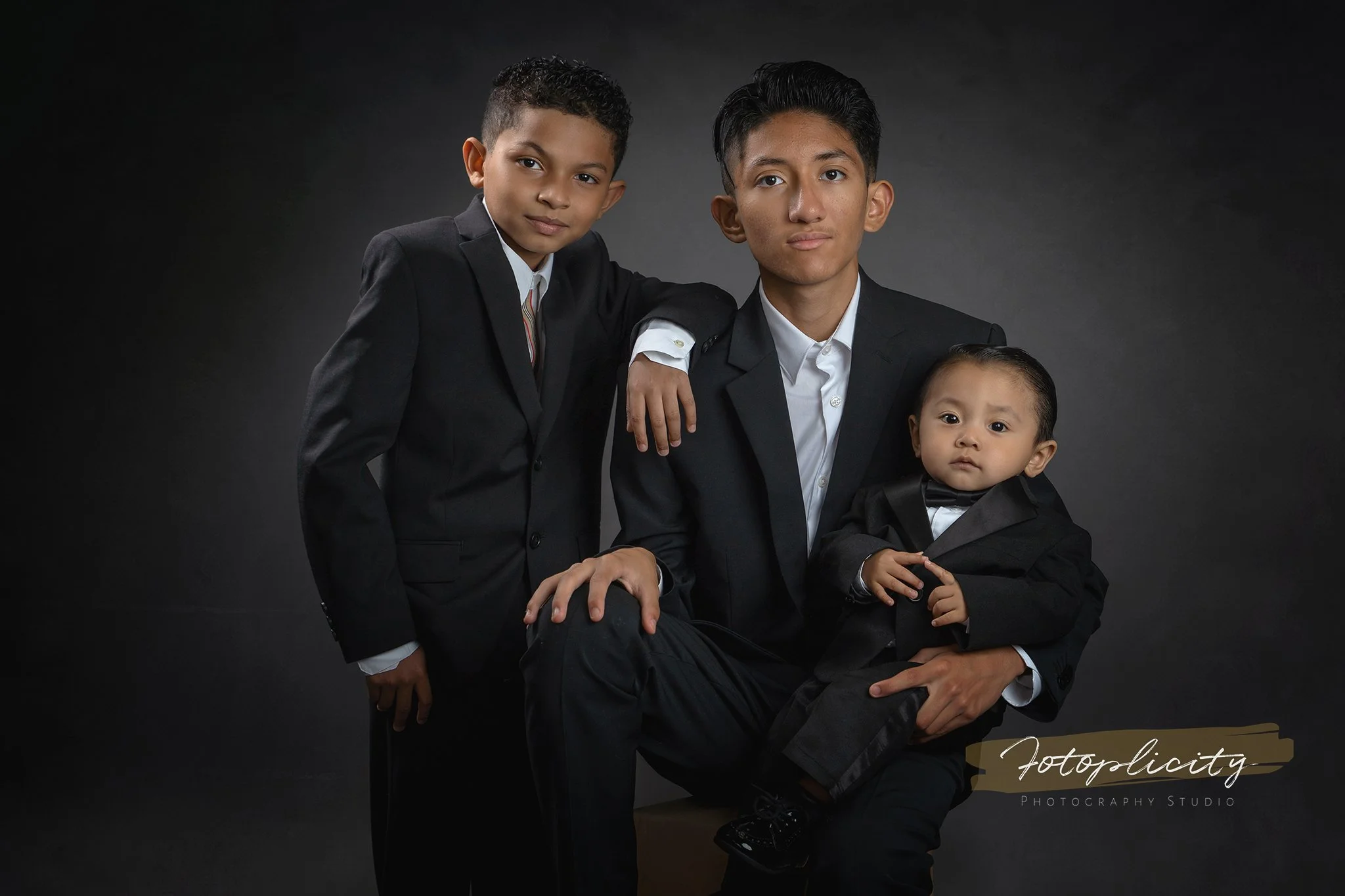 Three brothers in suits during studio portrait session at Fotoplicity — East Brunswick, NJ children's photographer