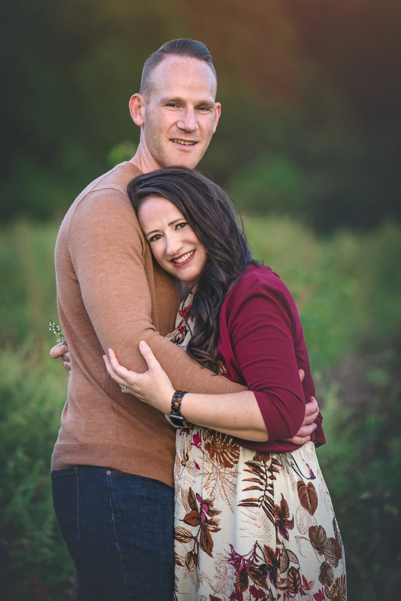 Parents embracing during a natural light outdoor family photography session in North Brunswick, New Jersey.