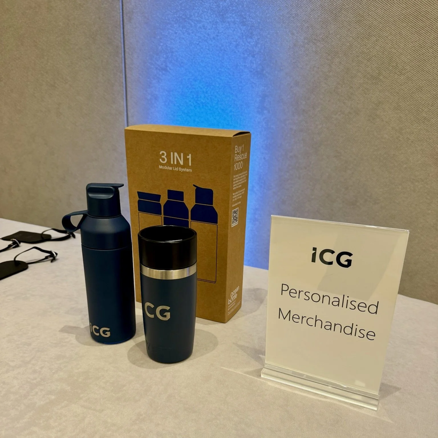 Personalised water bottles displayed beside ICG event signage