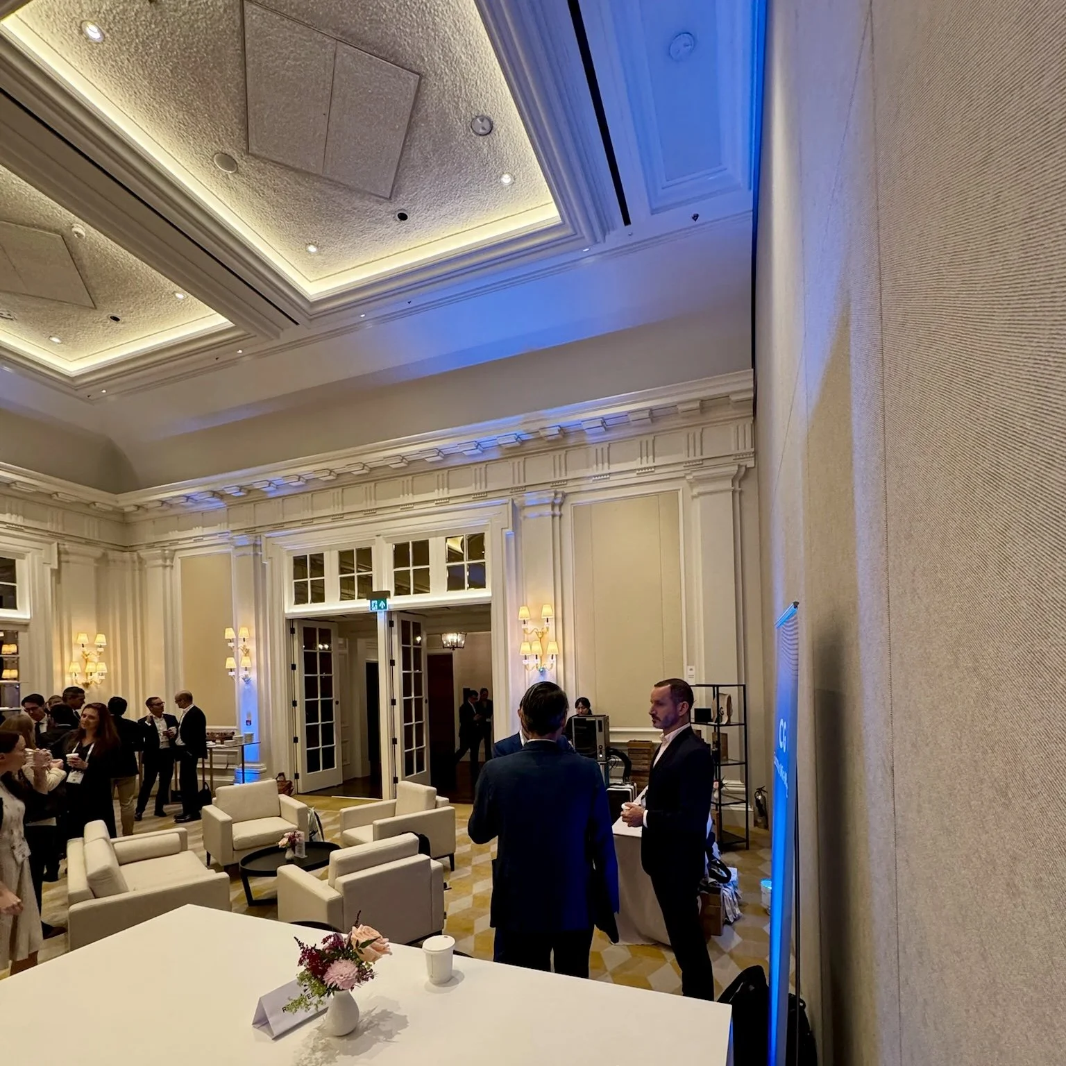 Conference venue interior with guests and event tables at The OWO