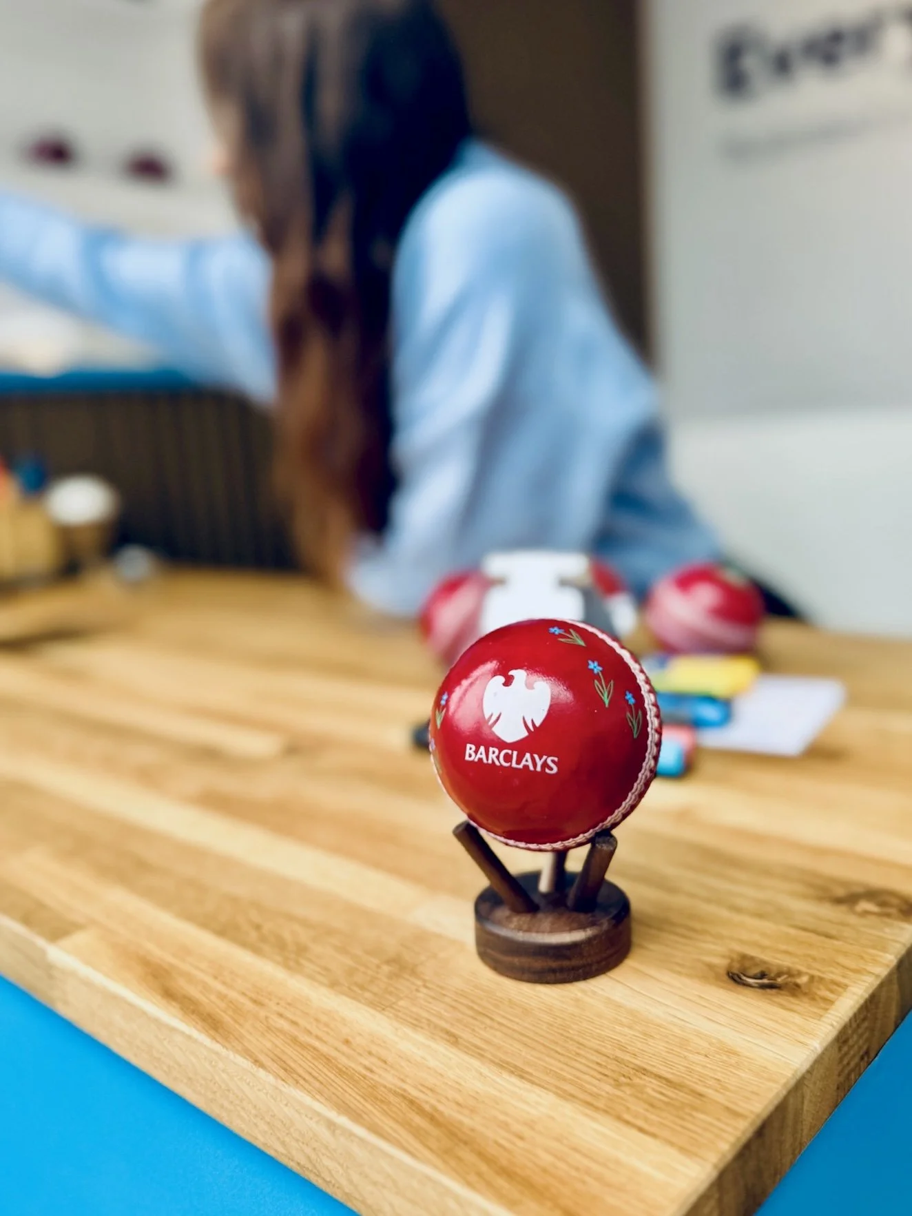 Cricket ball being personalised on a wooden printing station