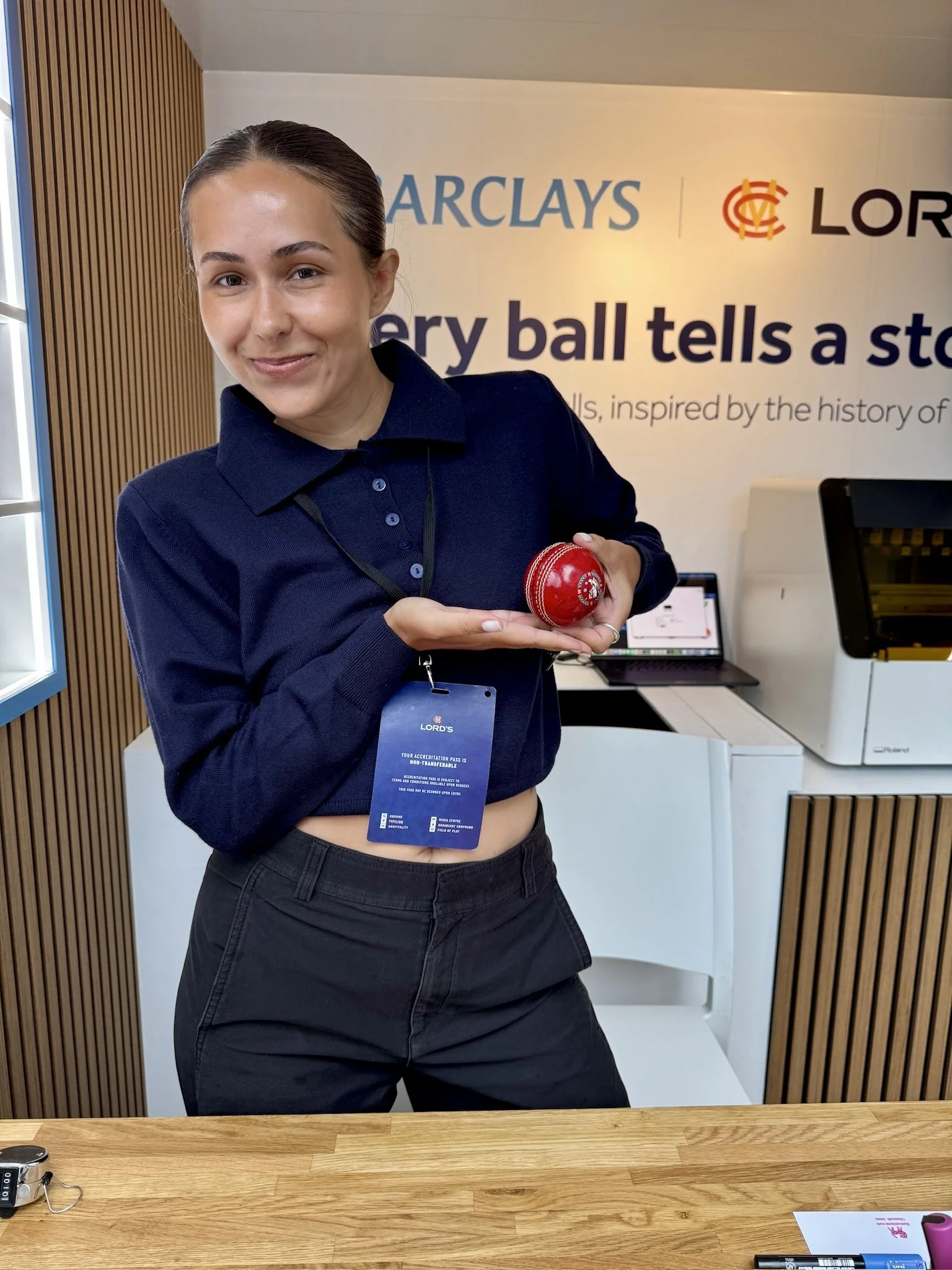 Barclays staff member at the live cricket ball printing counter