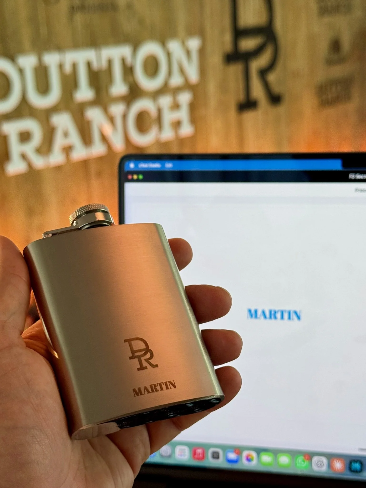 Close-up of a personalised hip flask featuring Dutton Ranch branding
