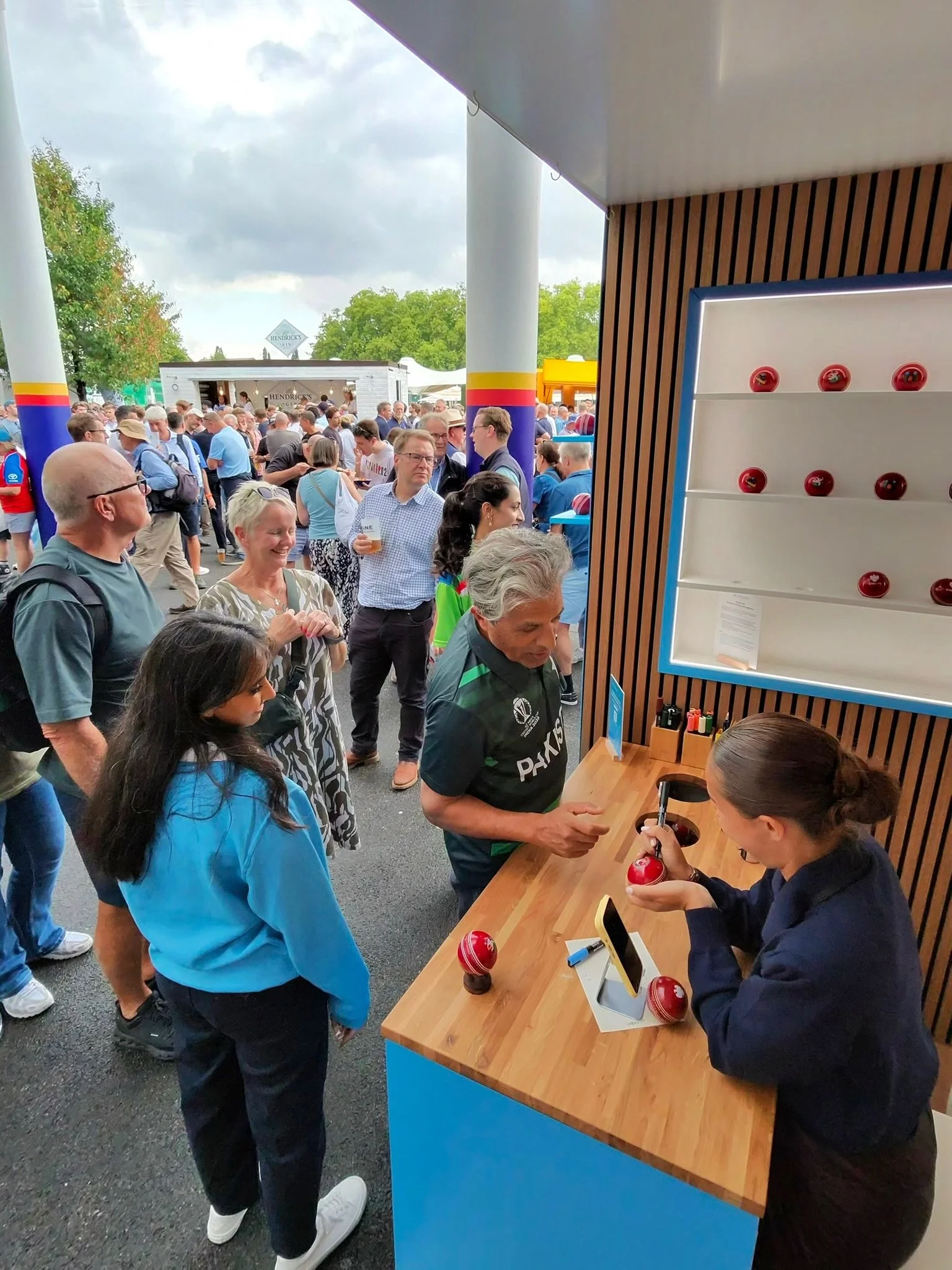 Visitors watching personalised cricket balls being printed live