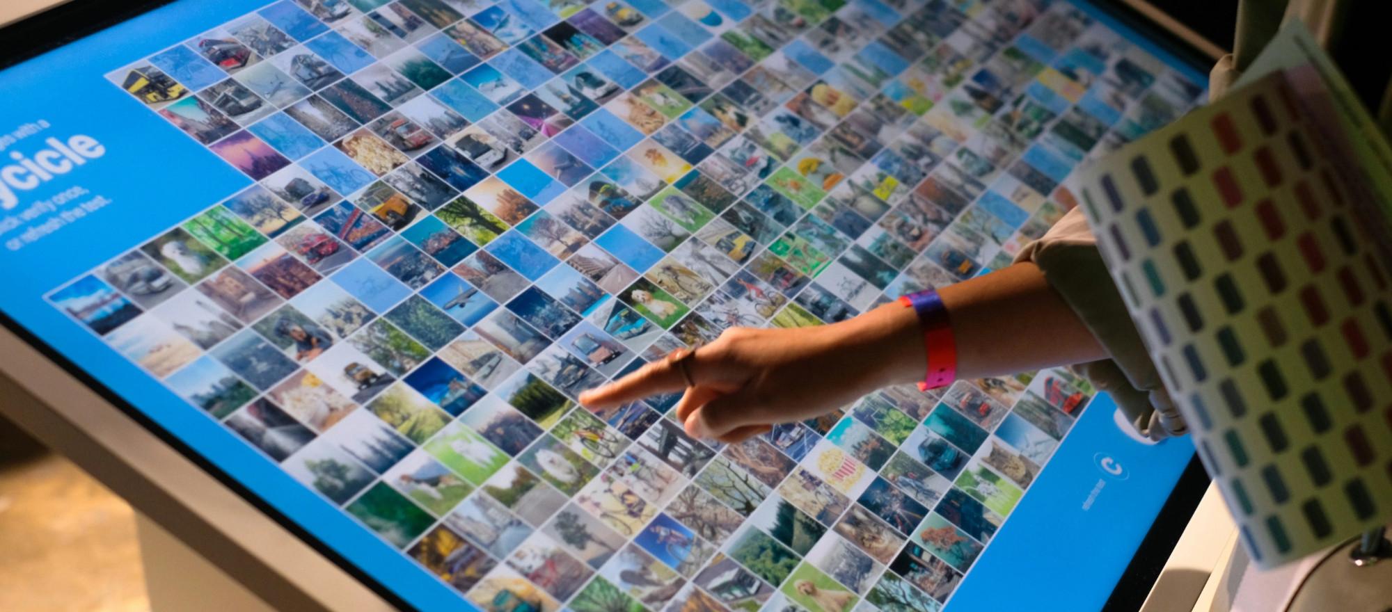 Person using a digital display to browse a large collection of images