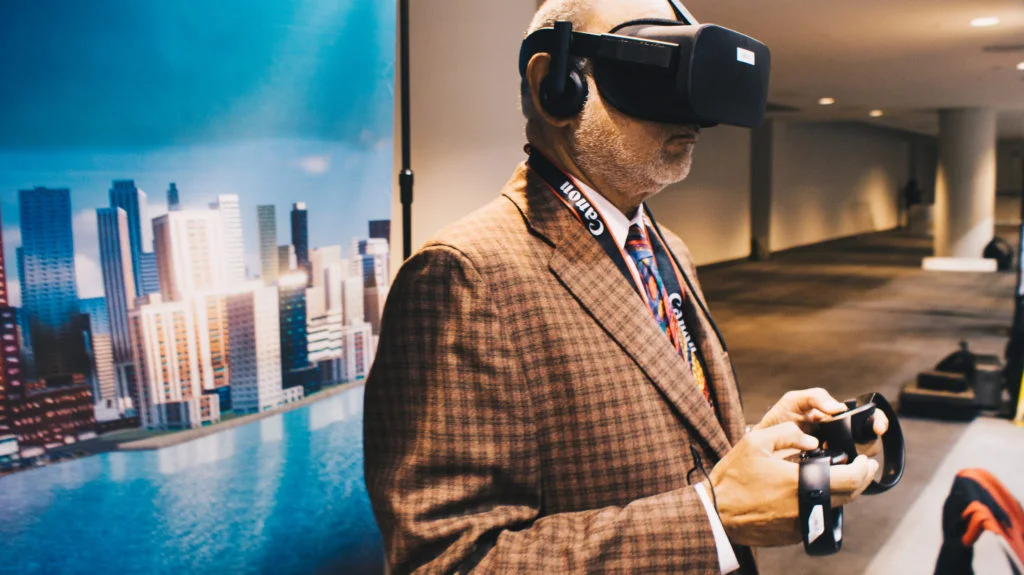 An NYVR Expo attendee tries the Oblix app with a view of Oblix’s banner in the background.