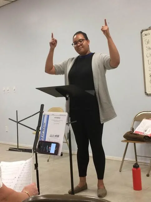Kimberly is either conducting or praying for a good concert