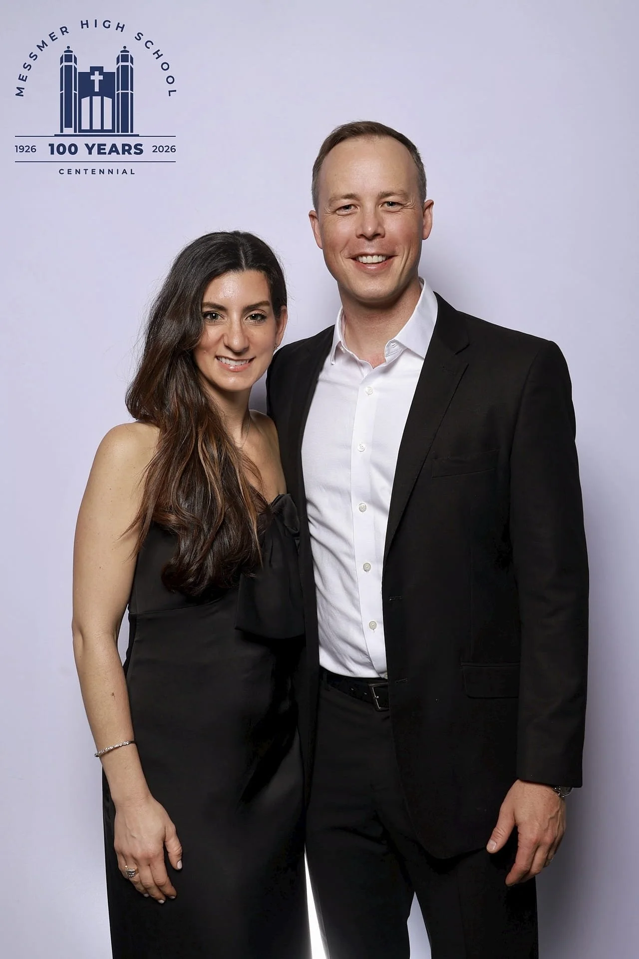 Formal couple posing at Messmer High School 100th anniversary photo booth at the Italian Community Center in Milwaukee