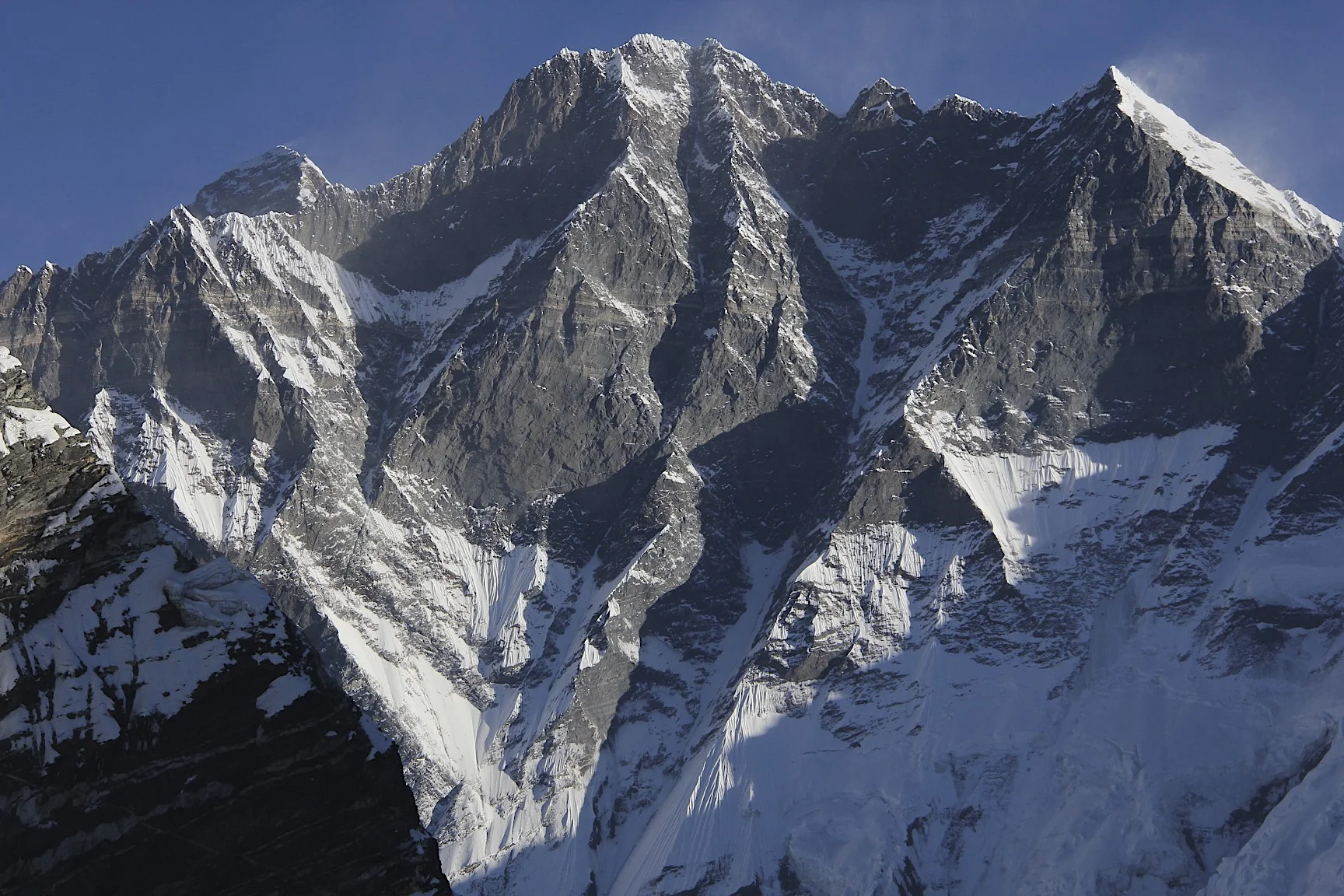 The south face of Lhotse with Mt. Everest peaking from behind the ridge.