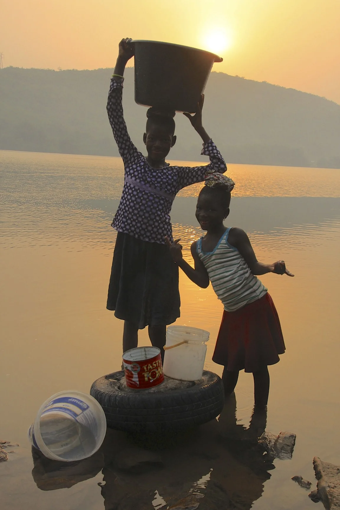 Local girls getting water in the morning from the River Volta