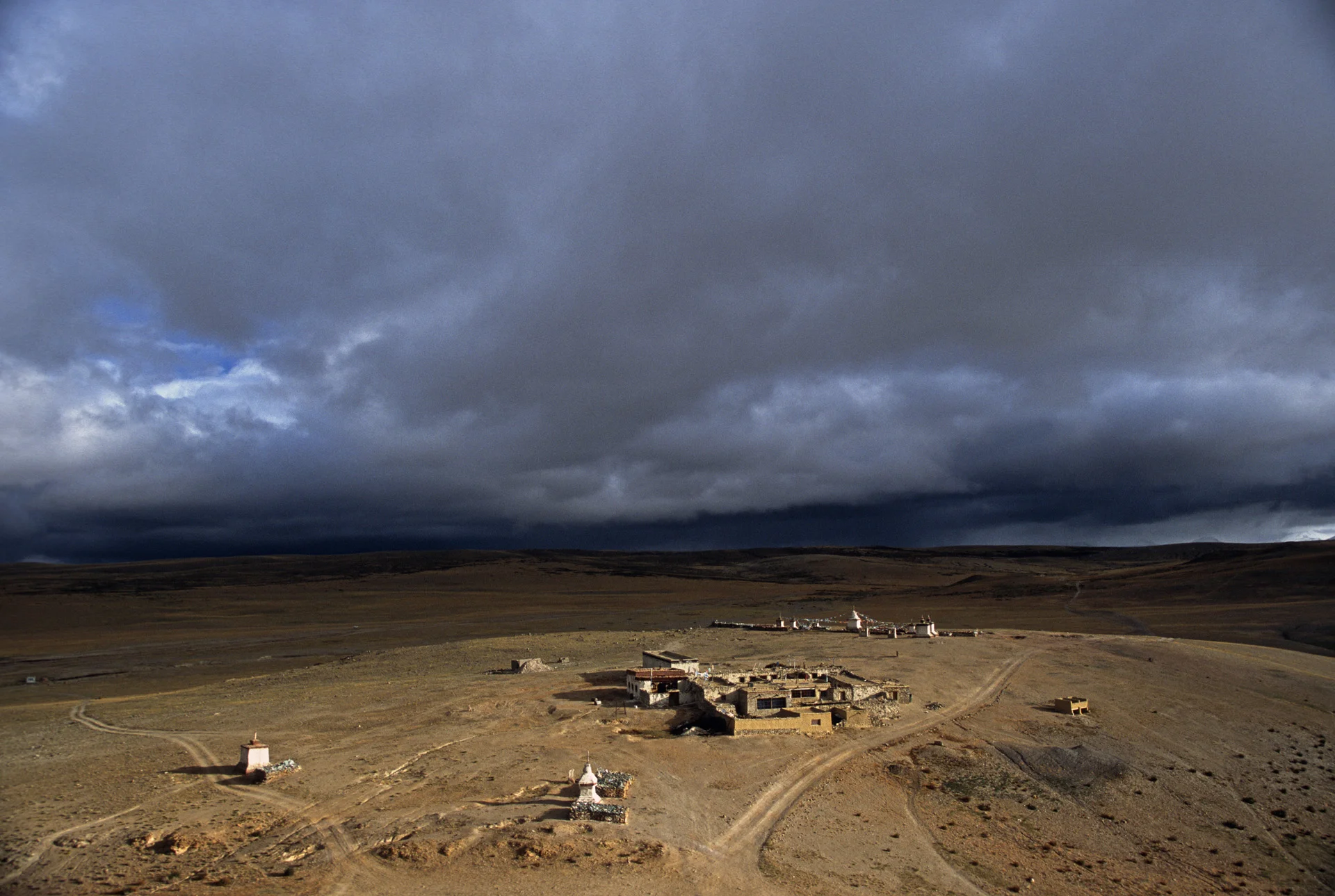 The stupas and a lone guesthouse on the hills overlooking Lake Manasarovar