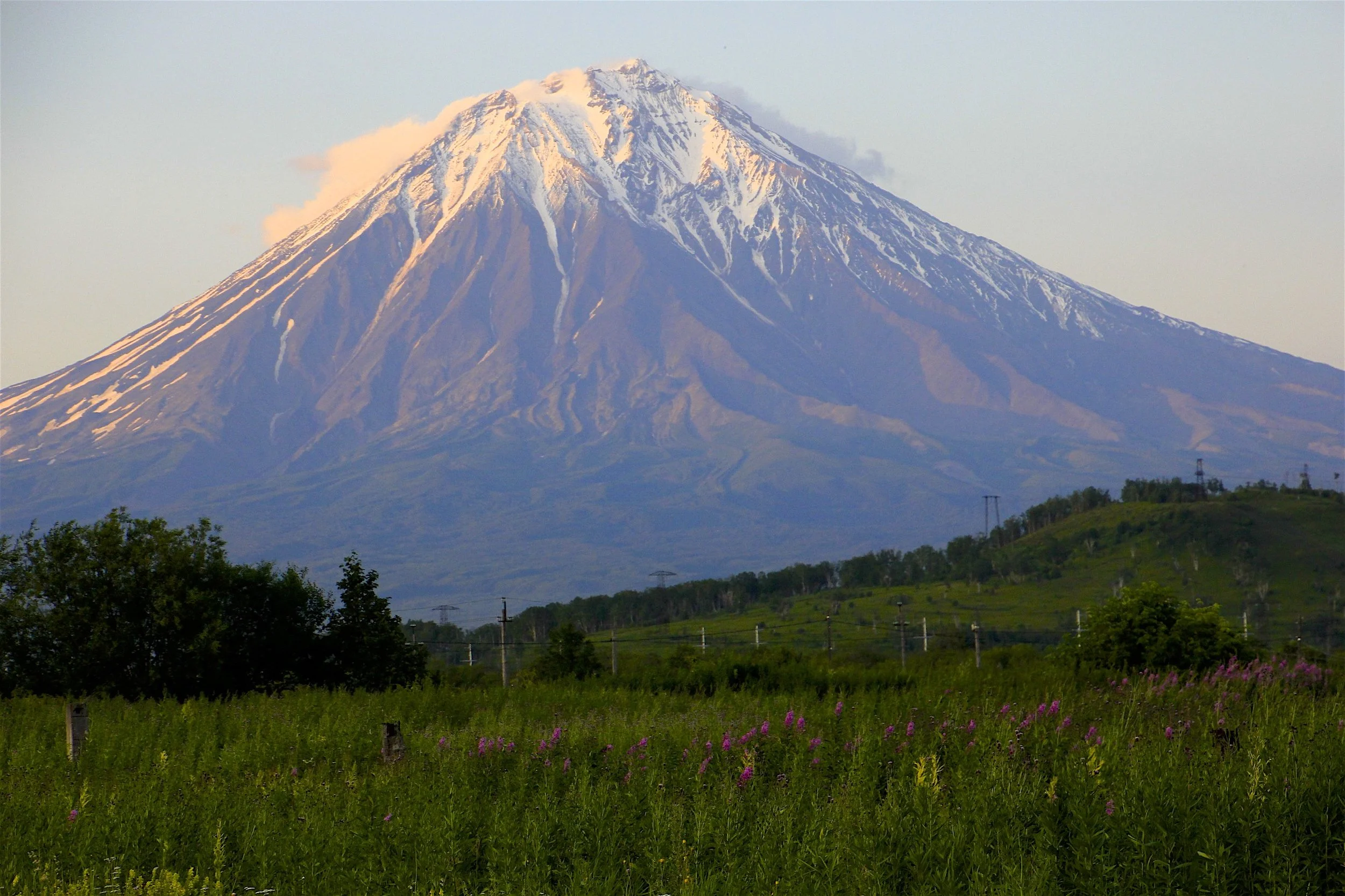 The Koryaksky Volcano near Petropawlowsk Kamchatsky (PK). It is 3,456m high. It belongs to the Avachinskaya group of Volcanoes. It had a small eruption of ash in 2009 forcing landing aircraft to change course. the upper part has a 35 degree slope and some exposed rocky sections.