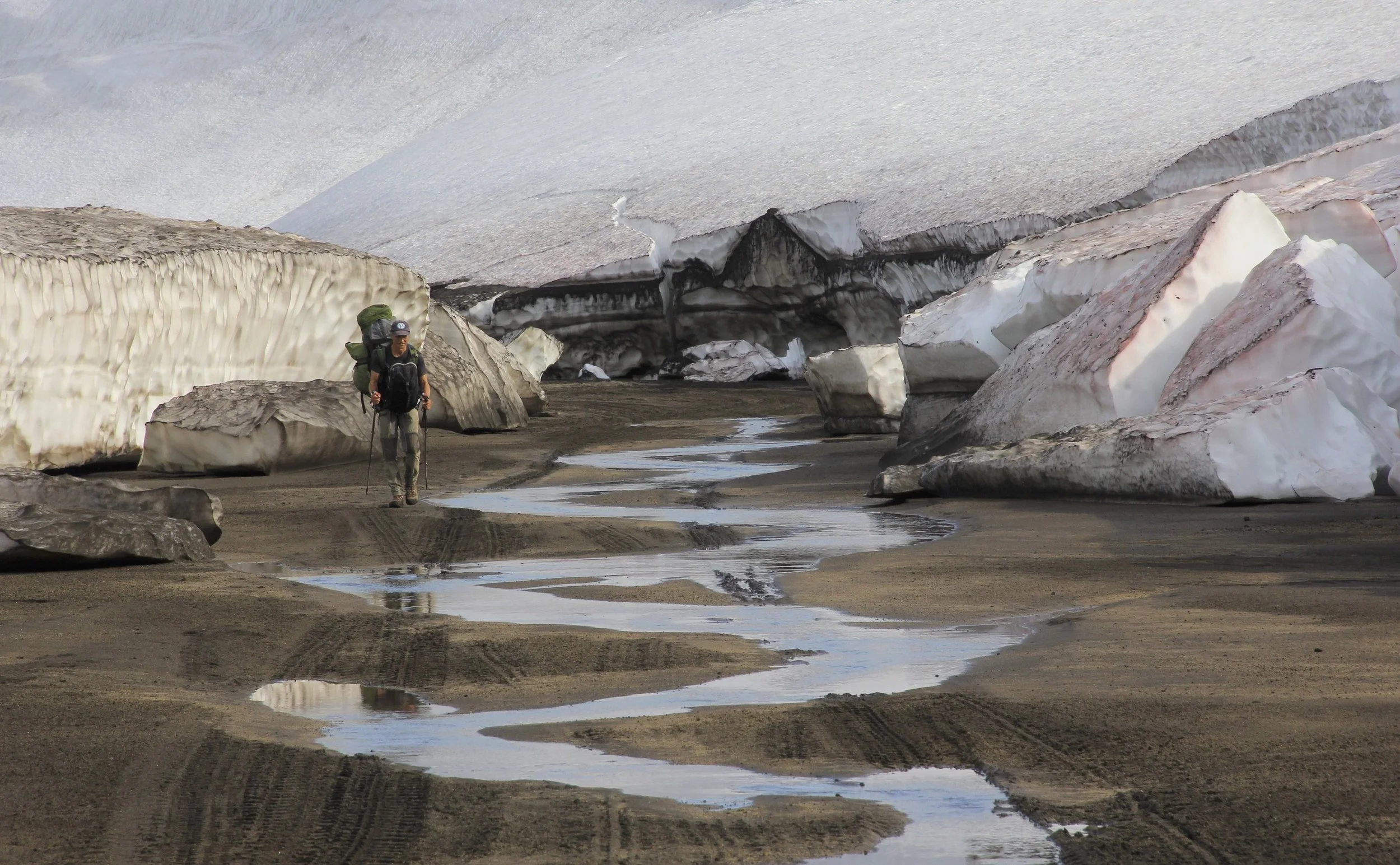 Walking through the remains of the 15m snow drifts!