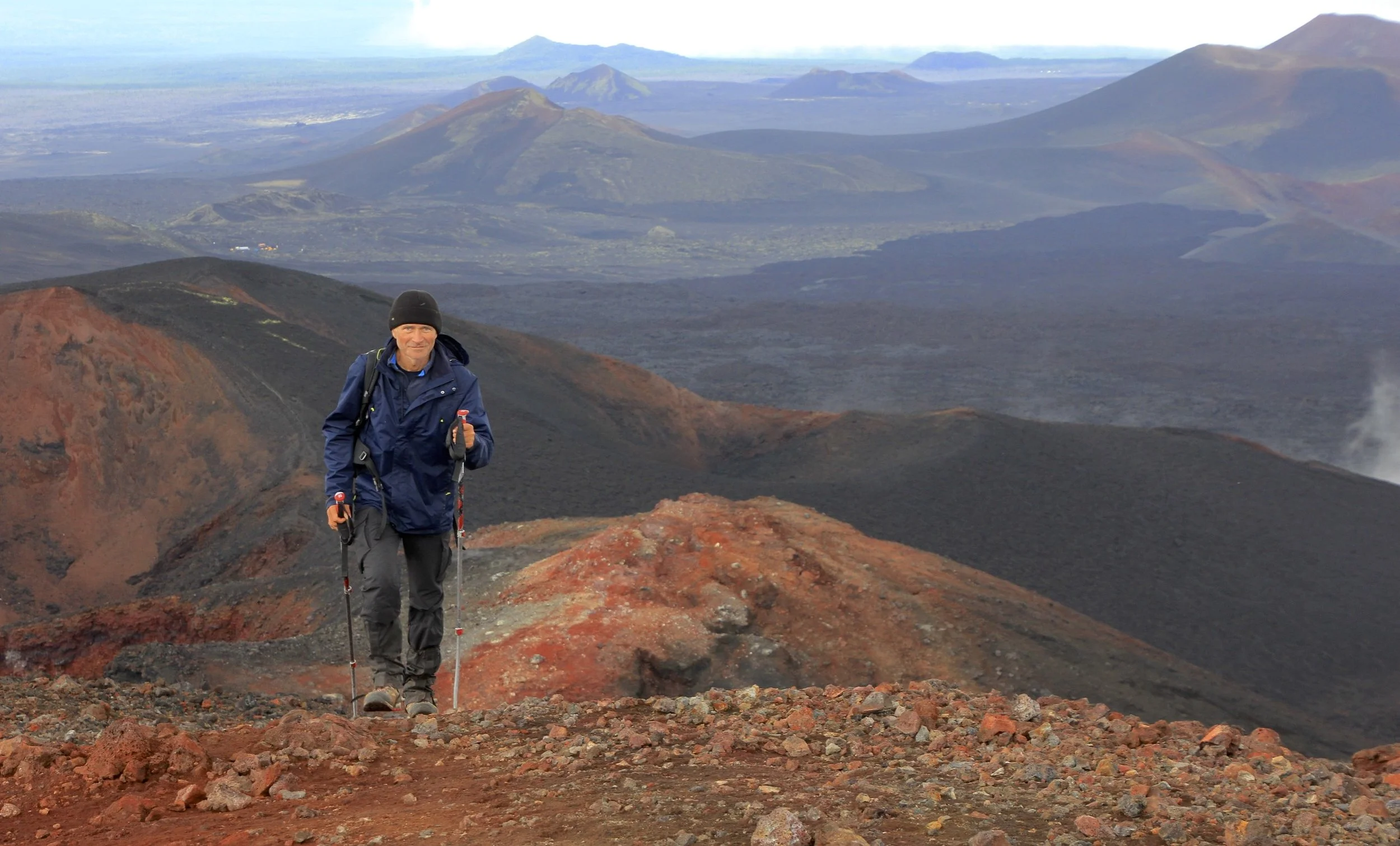 Evgeny marching to the top of the lava crater. Notice the basecamp on the left.