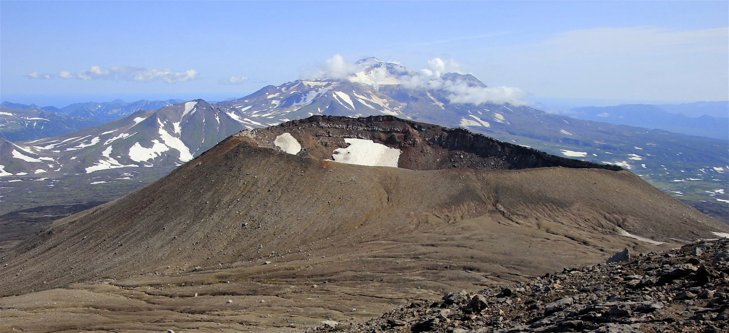 An unnamed crater of the Gorely Volcano and Mutnowski Volcano behind.