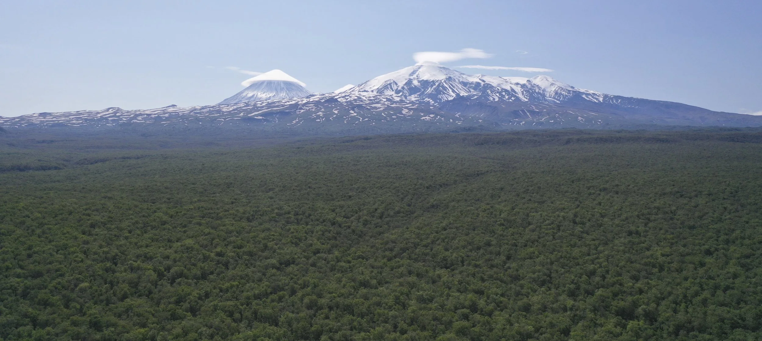 The Kluchewskaya Sobka 4,750m Volcano and Krestowski Volcano 4,057m and the endless taiga forest from the drone. We had to drive through this forest first to get to the trails. Photo by Evgeny Androssov.