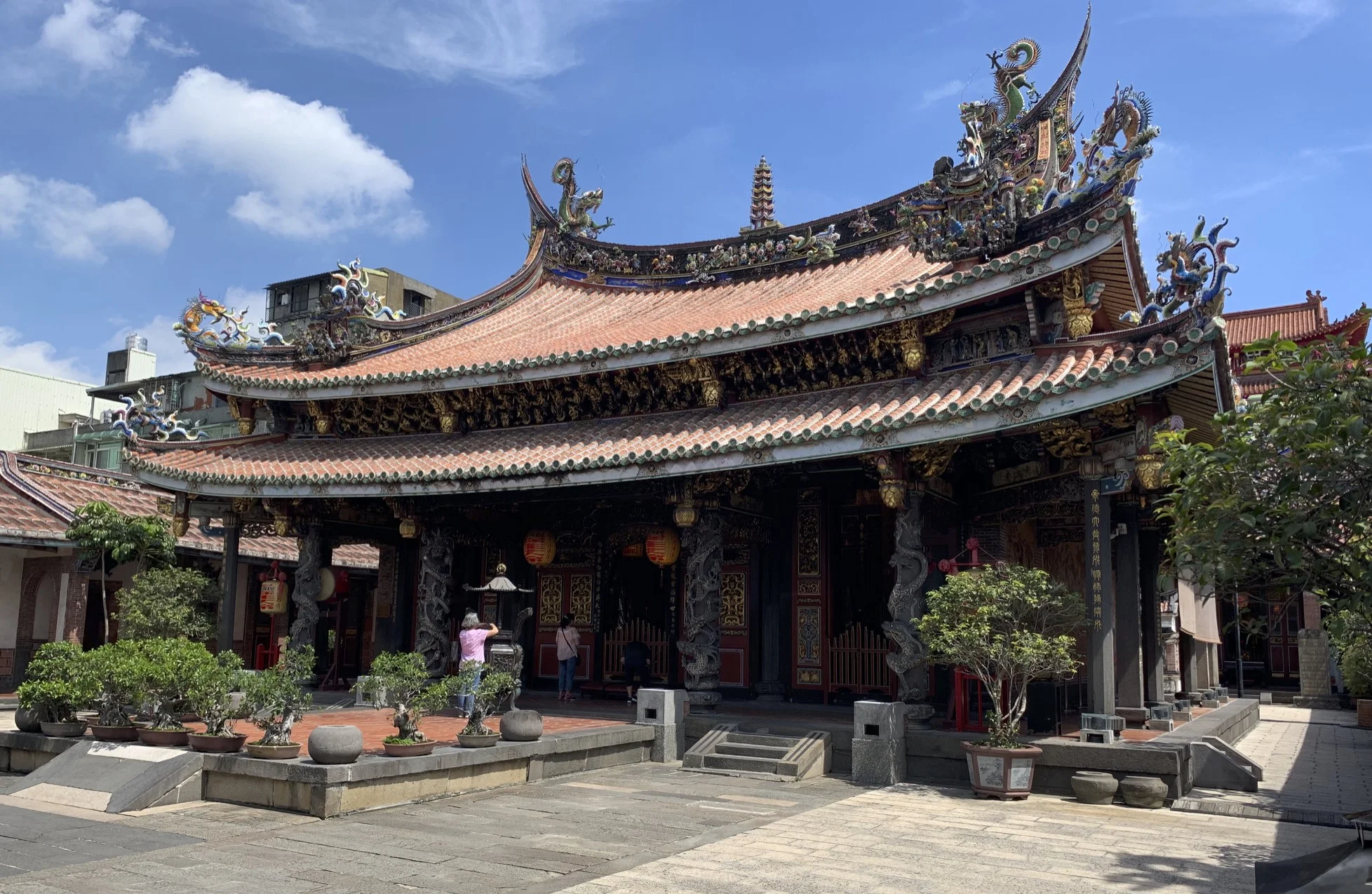 Originally constructed in 1742 as a wooden shrine, the Bao'an Temple is a Taiwanese folk religion temple. Throughout Taiwan's history, the temple was renovated and reconstructed numerous times, leading to a 2003 induction into UNESCO for cultural heritage conservation. Dedicated to the Taoist saint Baosheng Dadi (保生大帝) , the 900 SQ METRE large temple faces south, in line with Feng-Shui practices, and houses the front, main, and rear halls, along with the east and west halls. The buildings also run from tallest to shortest in that order, in observance of Confucian principles. The temple also houses a drum tower. Important architectural elements around the temple grounds include stone carvings, stone lions, dragon columns, stone bamboo windows, and wood, stone, and clay carvings.