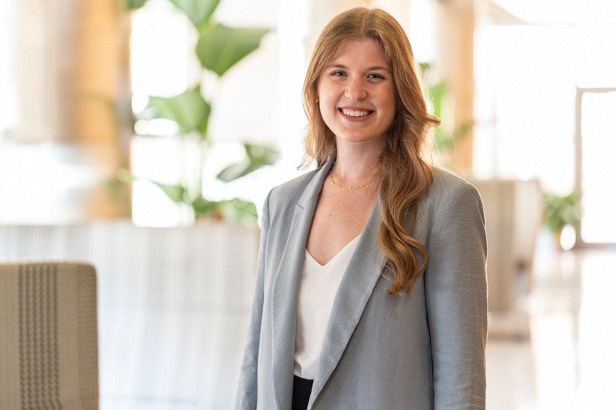 A smiling woman with shoulder-length blonde hair, wearing a 