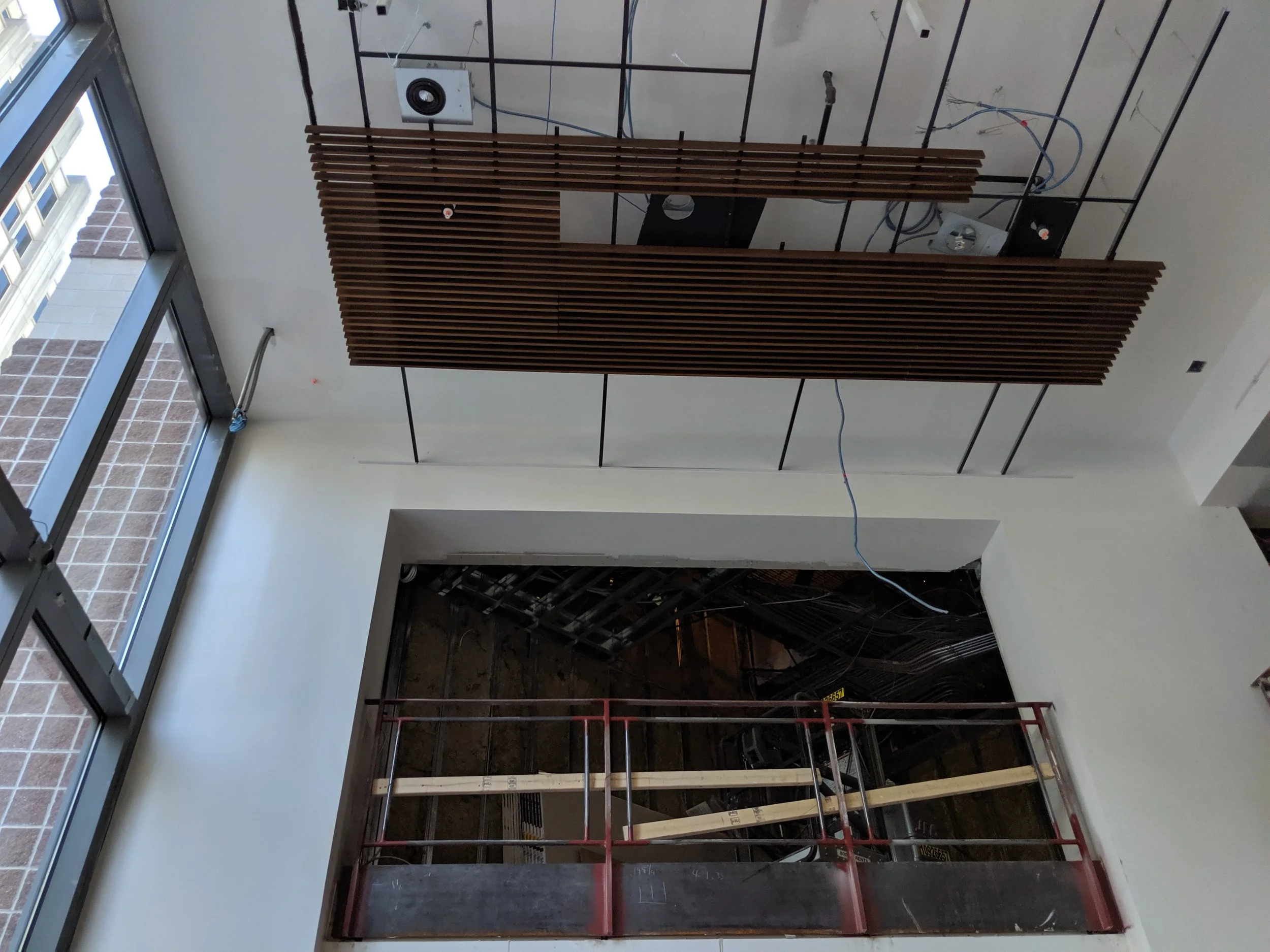 July 2019 - The wooden slates featured on the ceiling of the lobby were installed a metal grid.