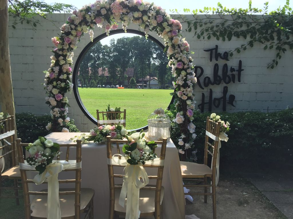 outdoor solemnisation with wedding arch and table chair decoration