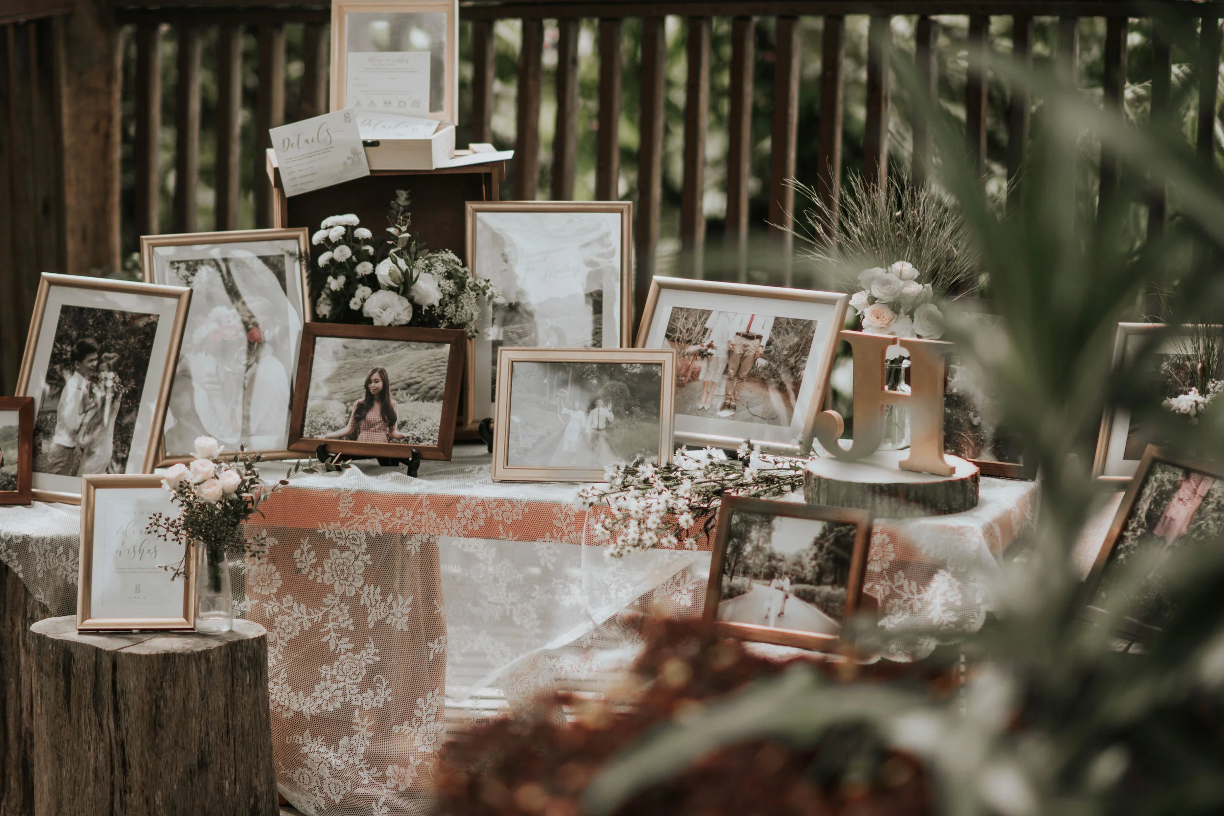 outdoor rustic style wedding decoration with flowers and photo frames