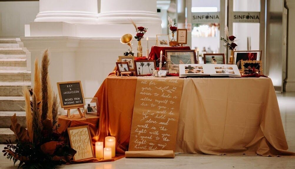 Pampas grass vintage burgundy wedding photo display table styling