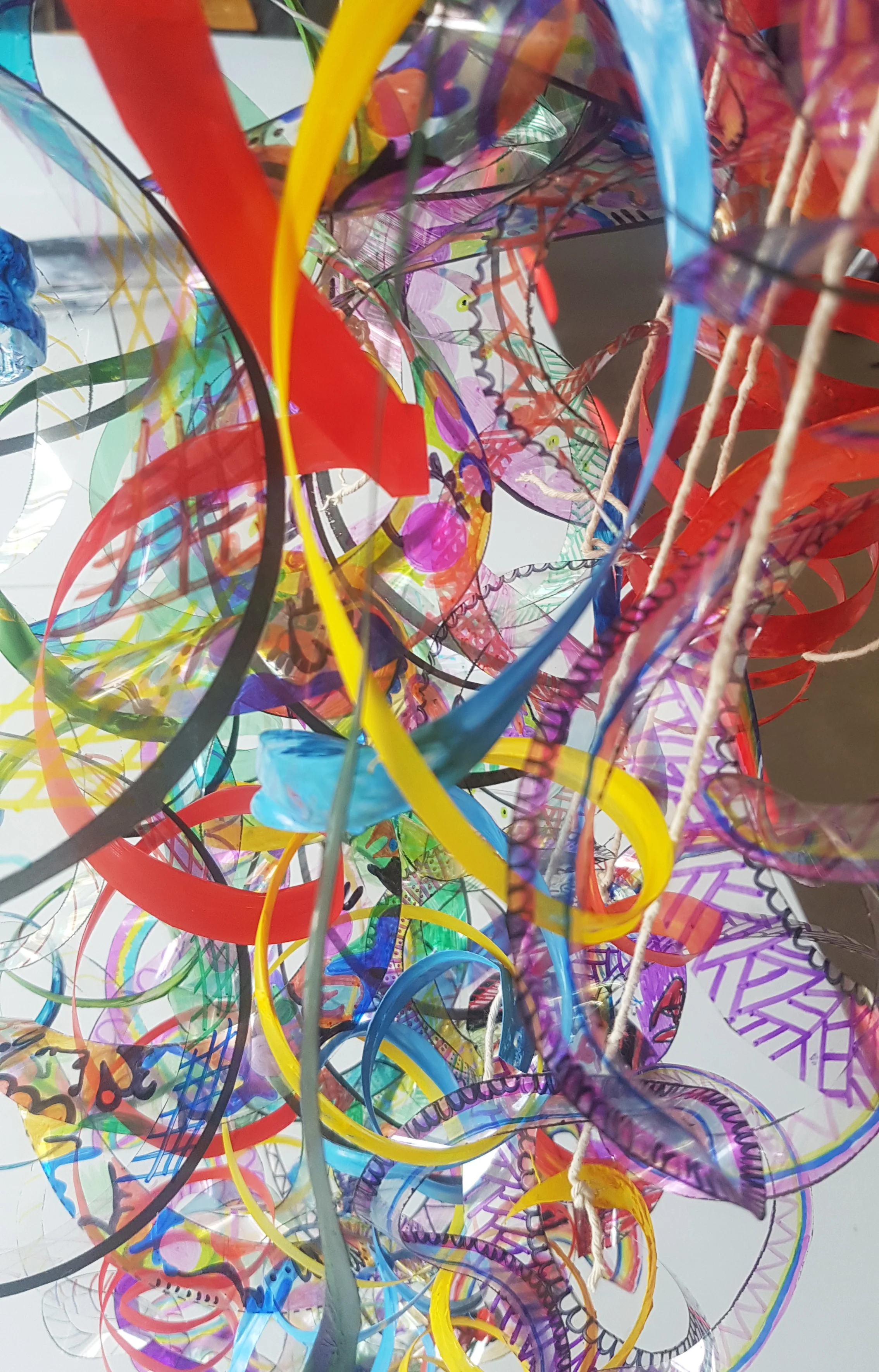 Creating a Dale Chihuly inspired spiral installation using acetate and recycled bottles.
