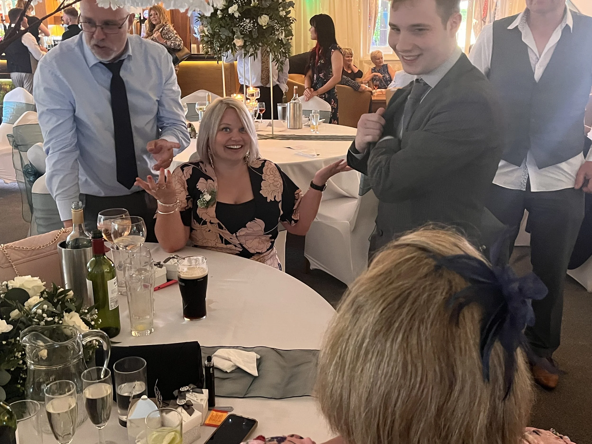 W women sits complete confused at a wedding after witnessing Jaies close up magic