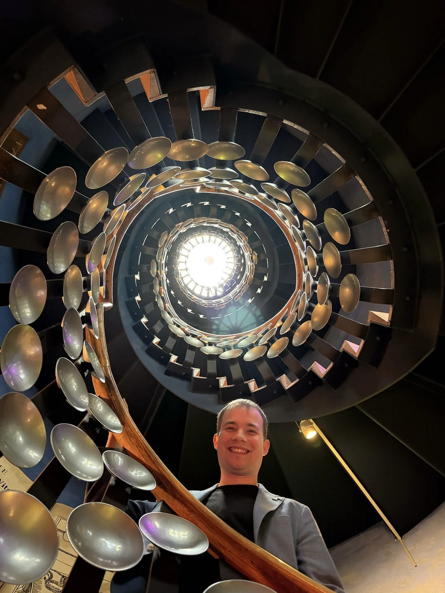 Jaie Proudly standing on the famous Magic Circle Staircase on the day of his exam