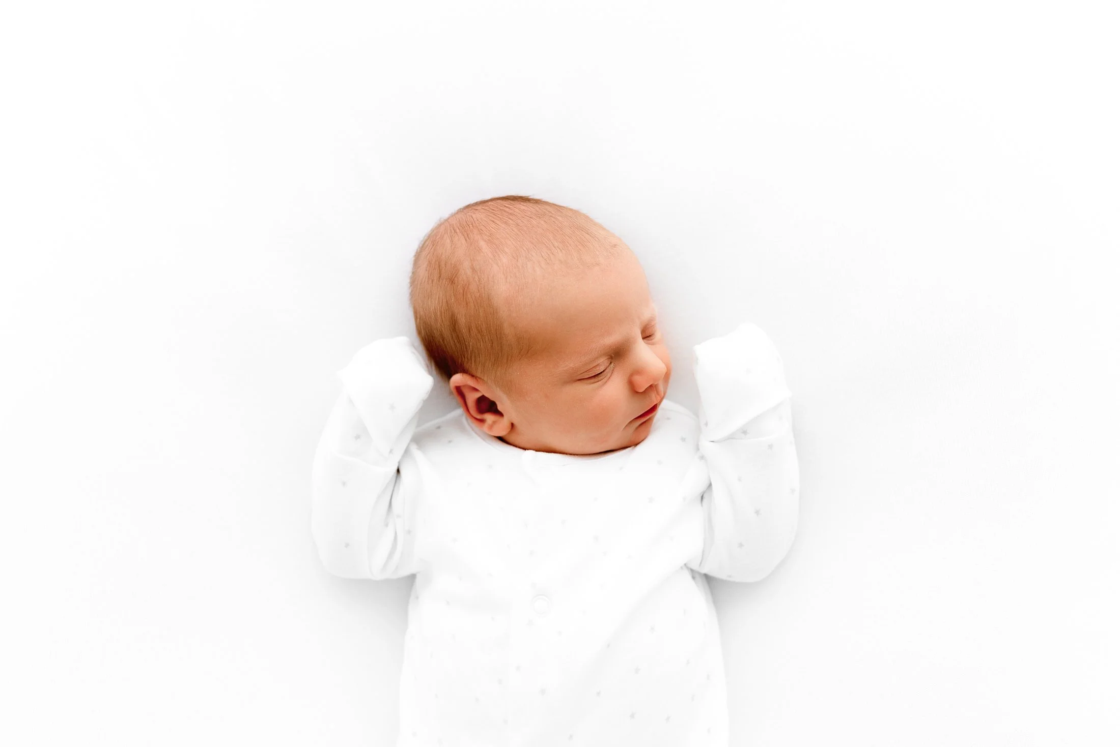 A calm newborn baby photographed during a relaxed studio photoshoot in Wokingham