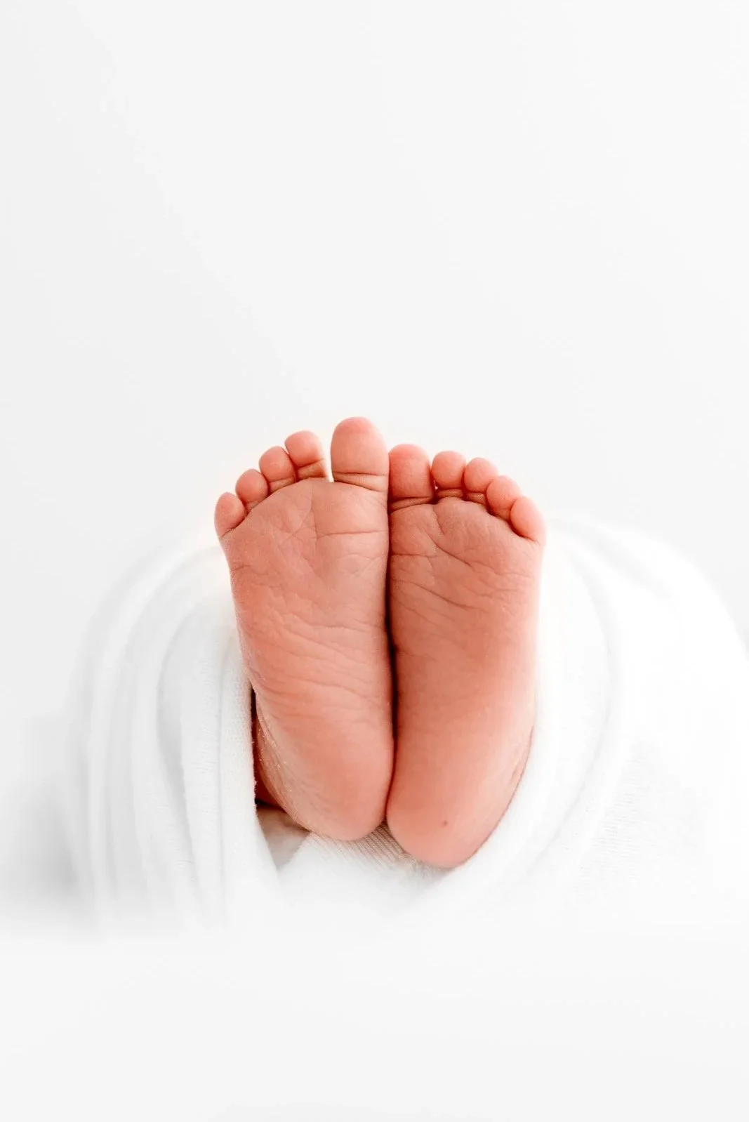 newborn detail photography capturing tiny hands and feet during early days