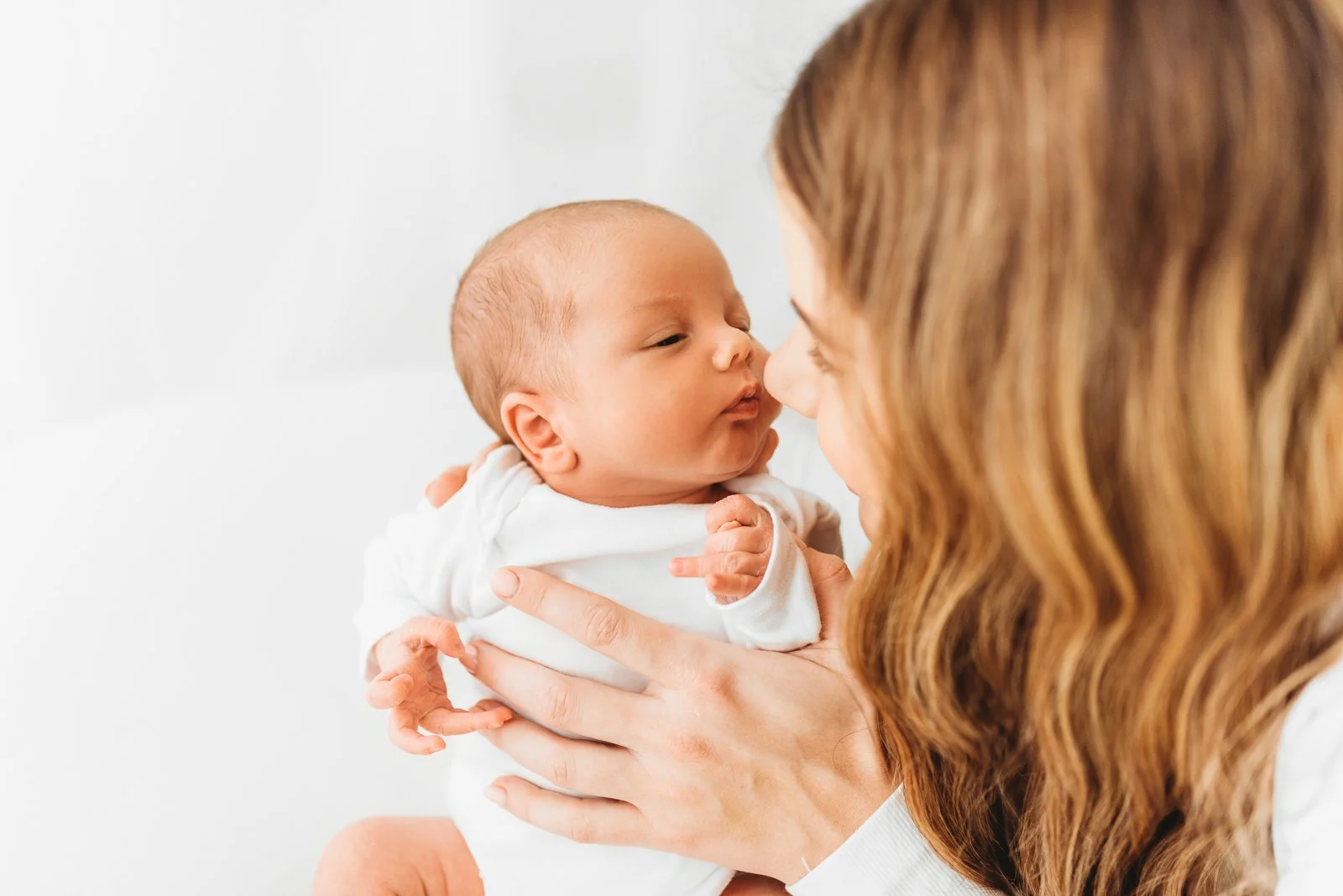 New Mum holding newborn baby during relaxed Winnersh photography session