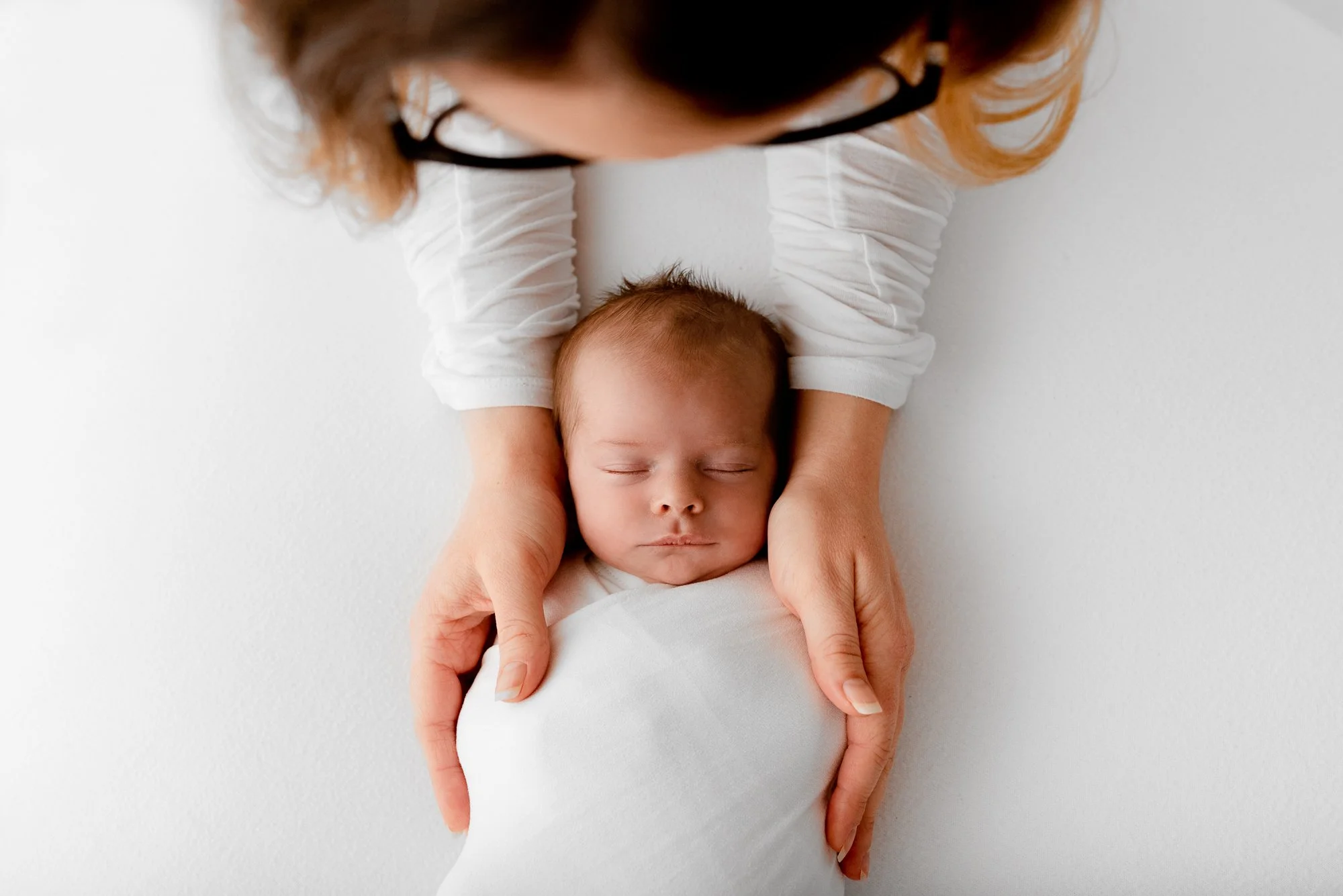 Sleepy newborn baby photographed during a relaxed studio photoshoot
