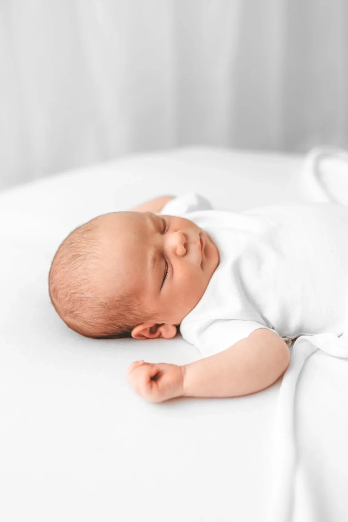 Newborn baby settled comfortably during a calm photoshoot experience