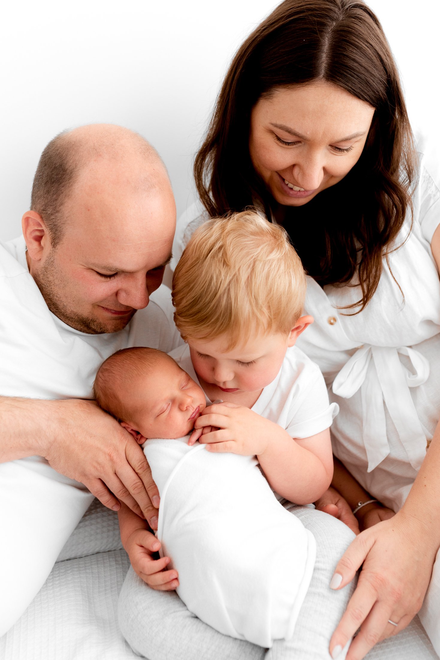 Newborn baby photographed in simple neutral tones during a photoshoot