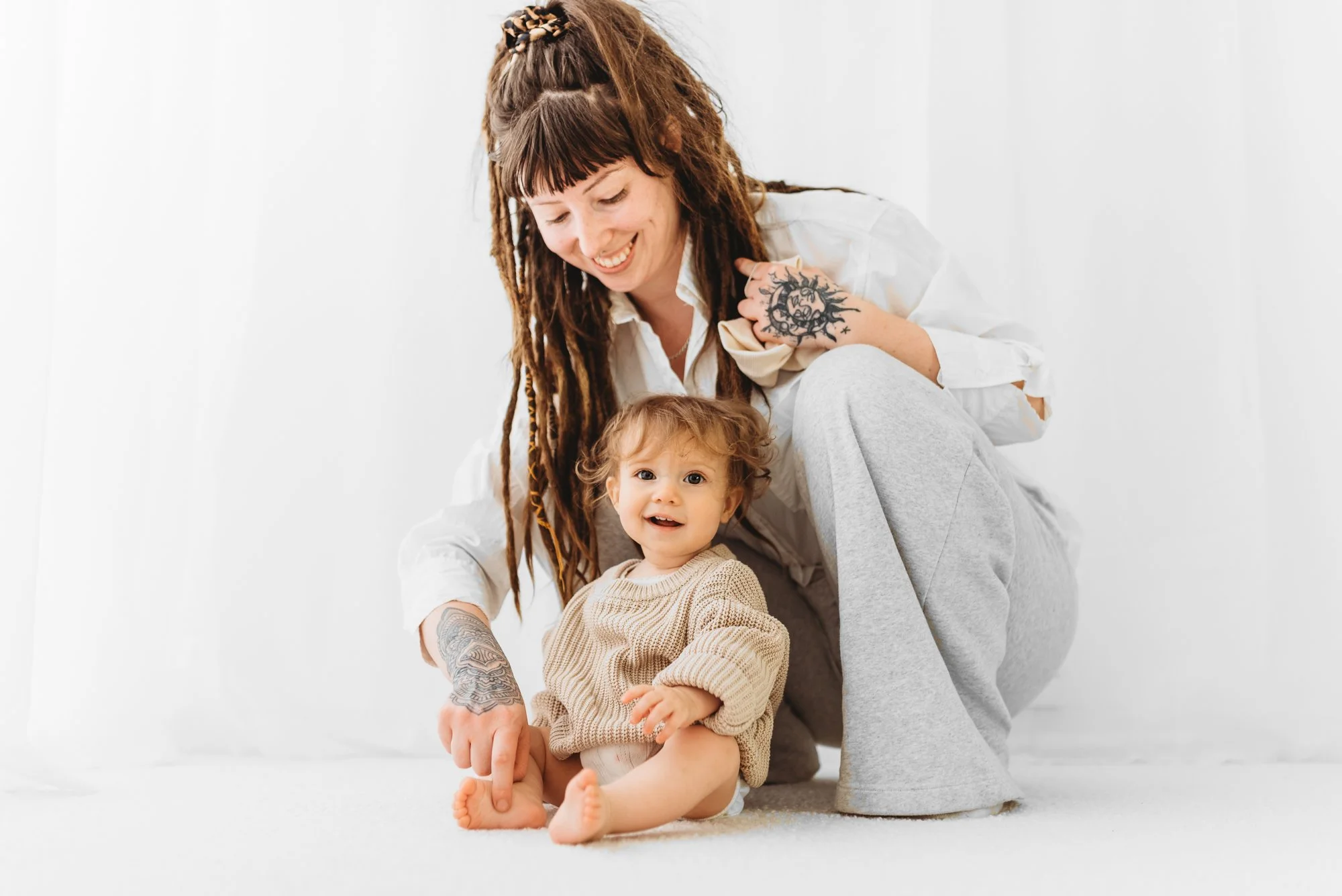 Mum playing with their baby during a milestone photography session