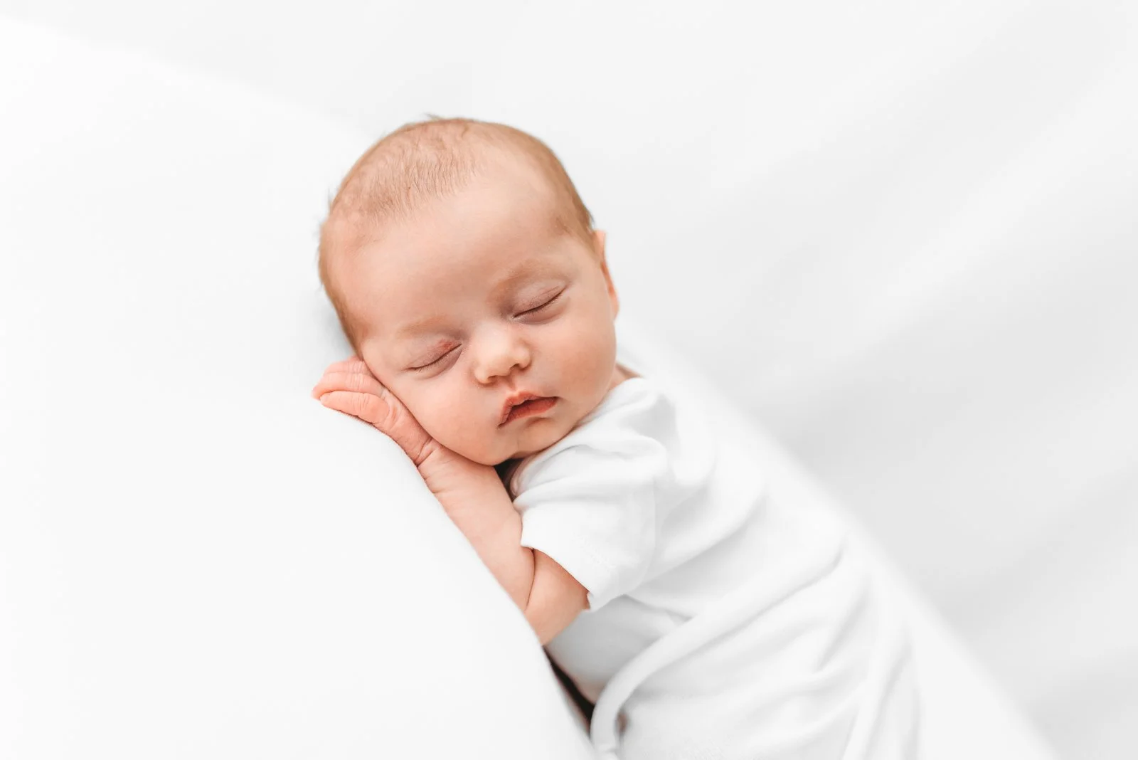 Sleeping newborn baby photographed in a calm, baby-led session in Wokingham Berkshire