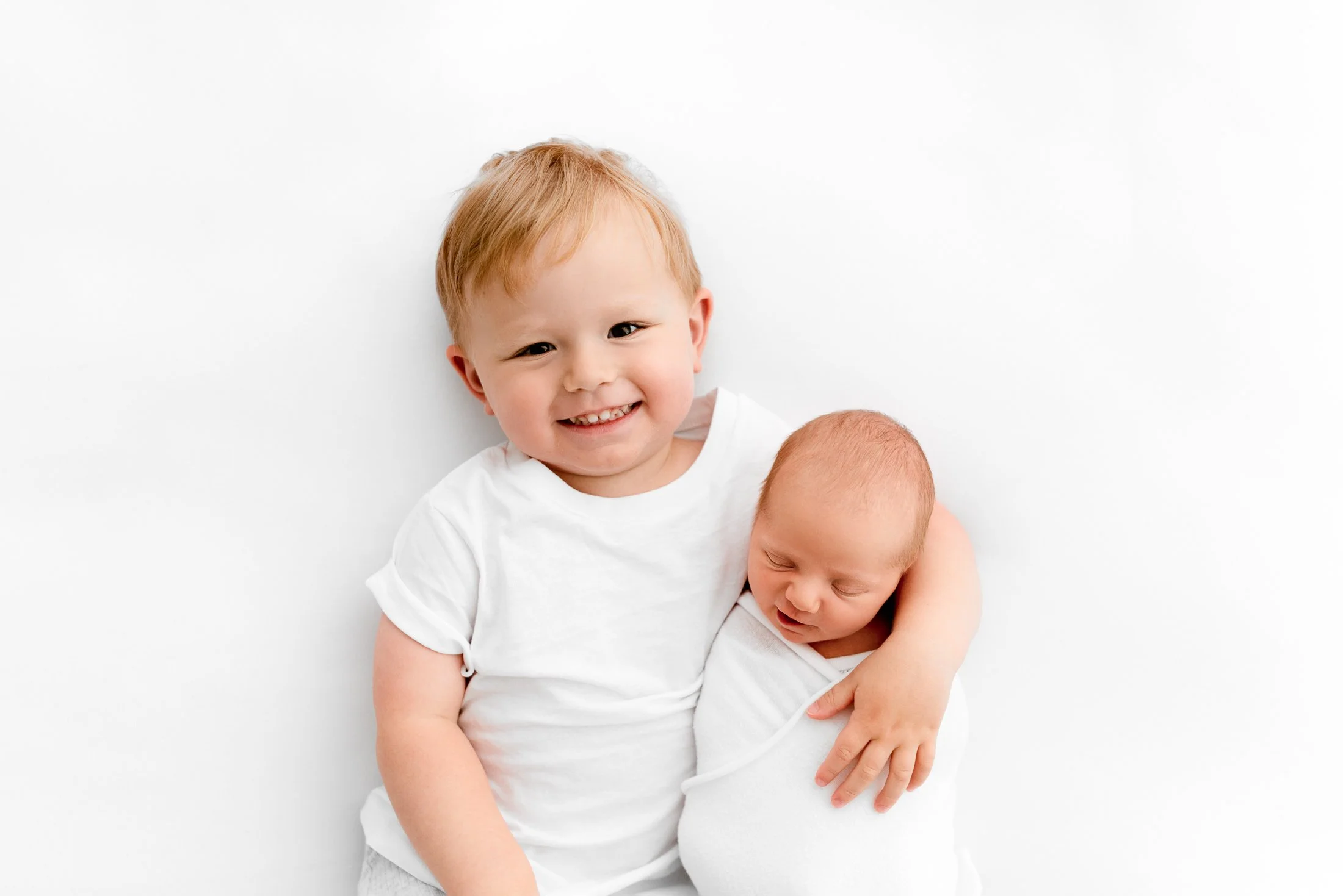 Sleepy newborn baby settled comfortably during a newborn photoshoot