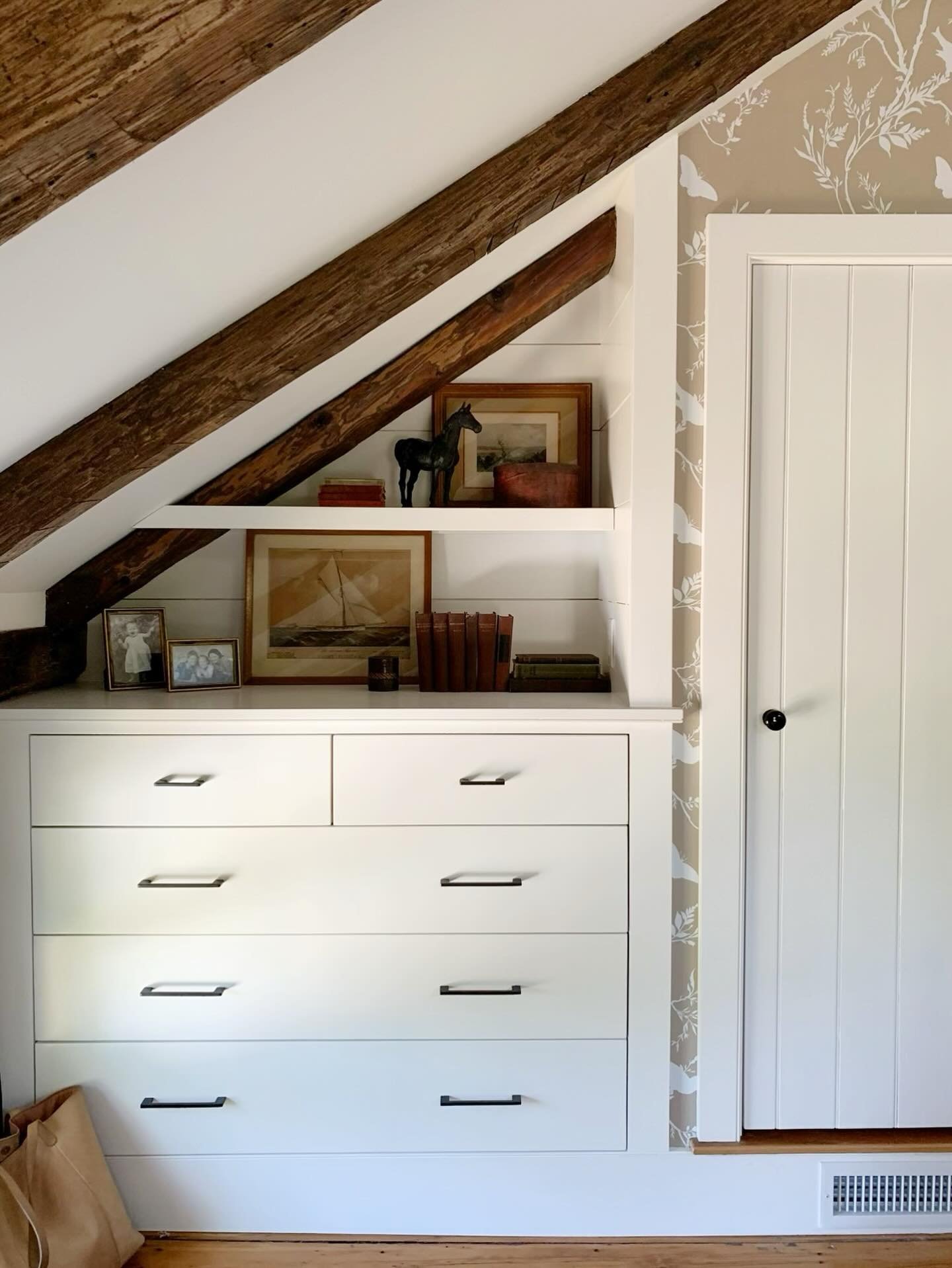 No storage, no problem. By bumping out the wall under the eaves, we were able to squeeze in both a cupboard and drawer space in this bedroom. And the little display shelf was an added bonus! It&rsquo;s the little things that make all the difference. 