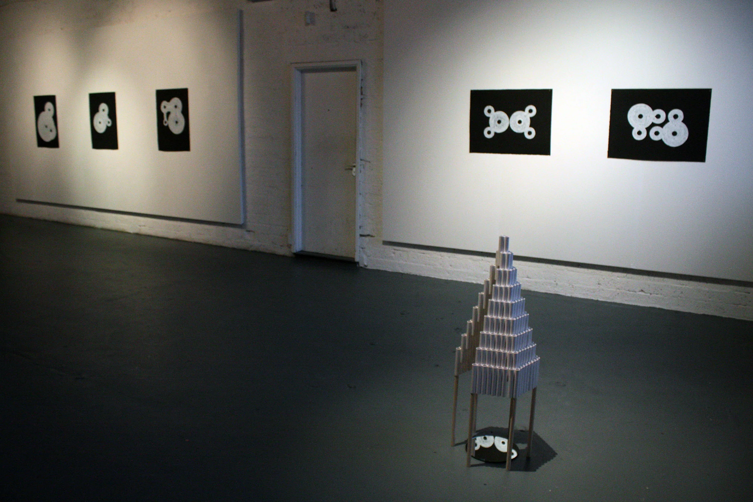 Installation view showing untitled sculpture and drawings