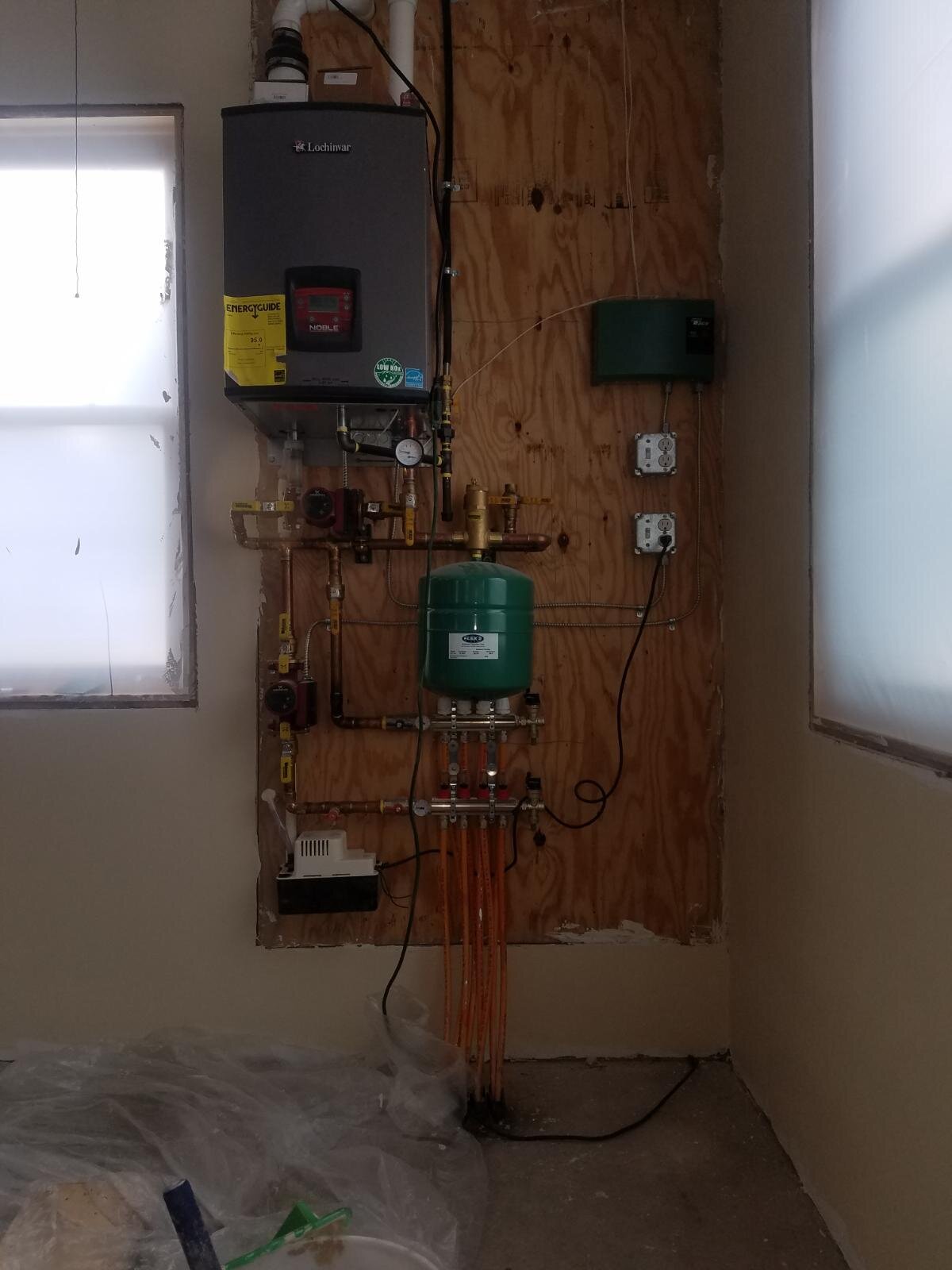  It doesn’t have to be complicated. This simple boiler system provides in-floor heat for a carpentry shop. 