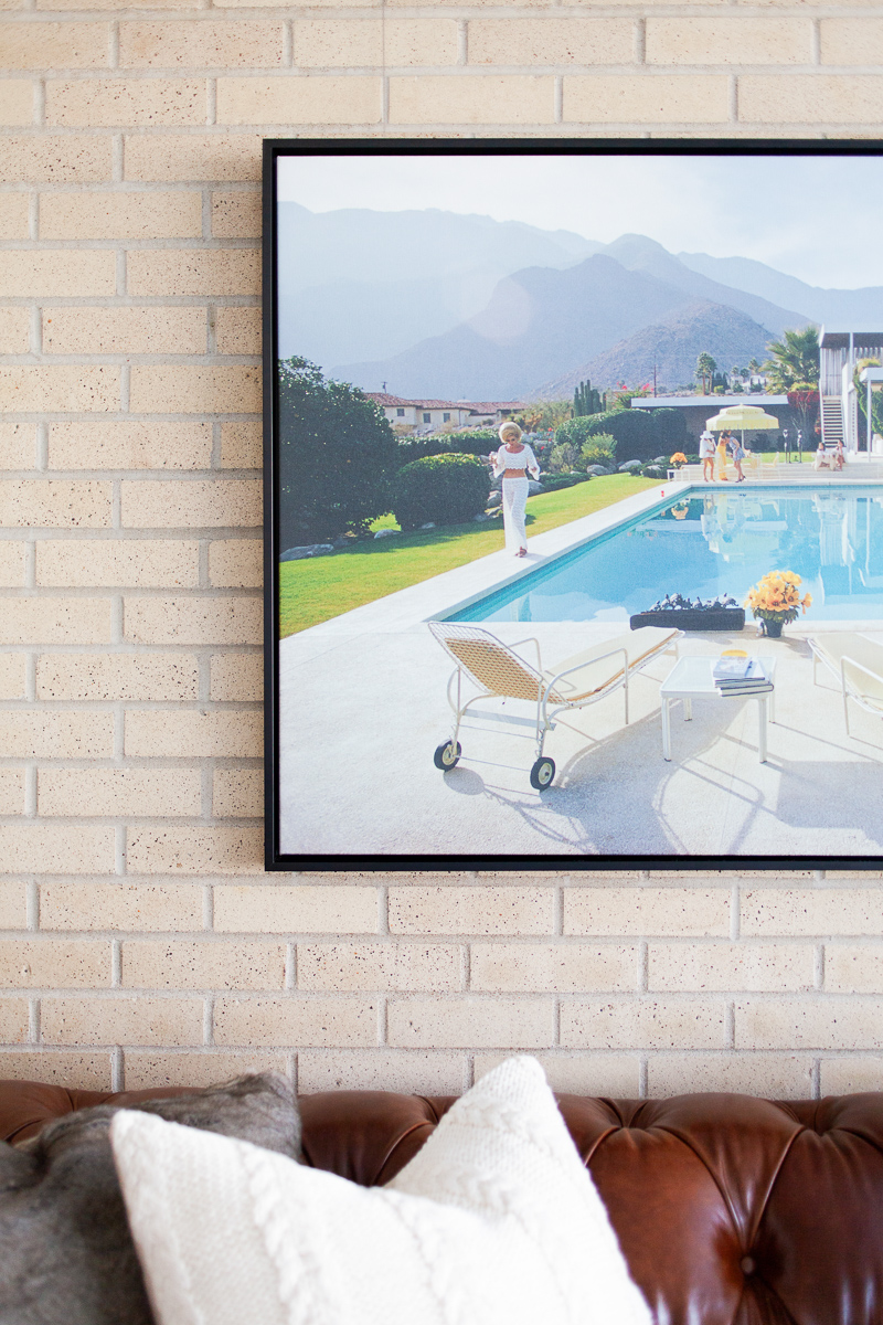 Poolside Glamour print by Slim Aarons. We reserved using saturated color in the rest of the space to really let this piece shine above the leather Chester Sofa .