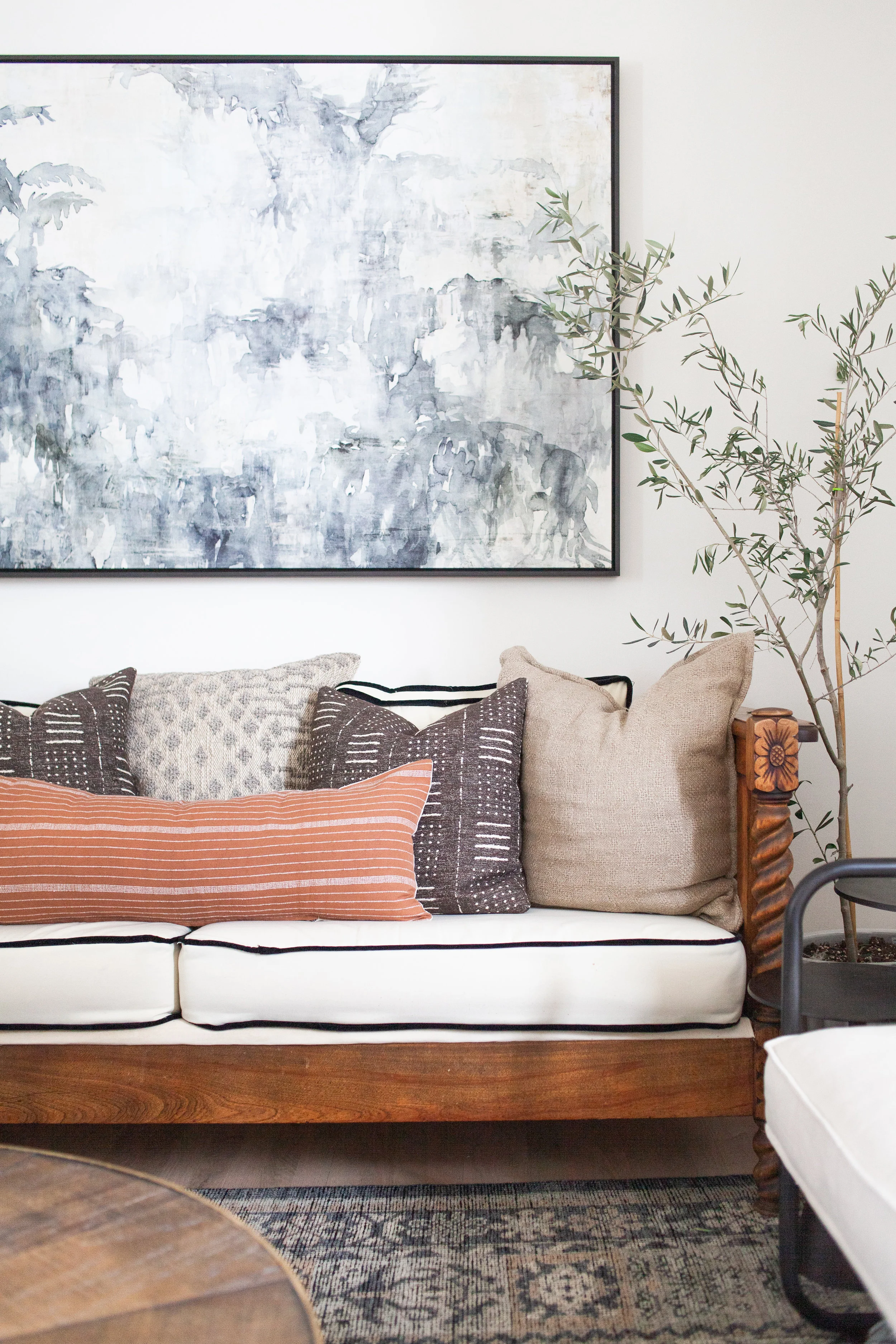 SHOP THE LOOK | Pacha Lumbar Pillow in Terra-Cotta ($250.00), Taupe Cotton & Wool Pillow ($119.00), Bone/Charcoal Heirloom Rug ($738.00 - $4,018.00), A Curious Place Framed Artwork ($462.00)