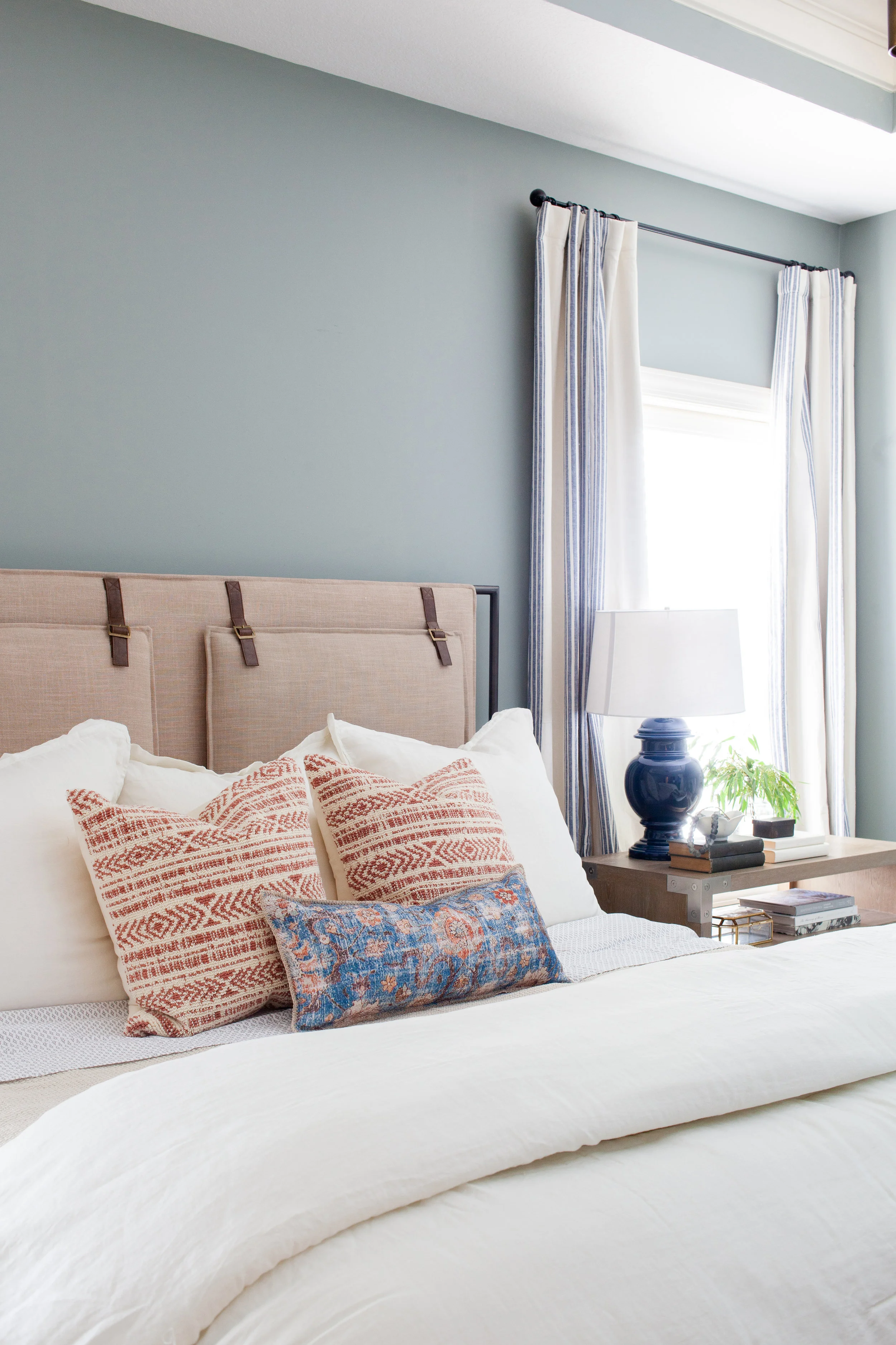 SHOP THE LOOK | Blue/Multi Lumbar Pillow ($69.00 - $89.00) , Leigh Upholstered Bed ($1,747.08), Keely Rust/Natural Pillow ($89.90), Shilo Nightstand ($1,368.00)