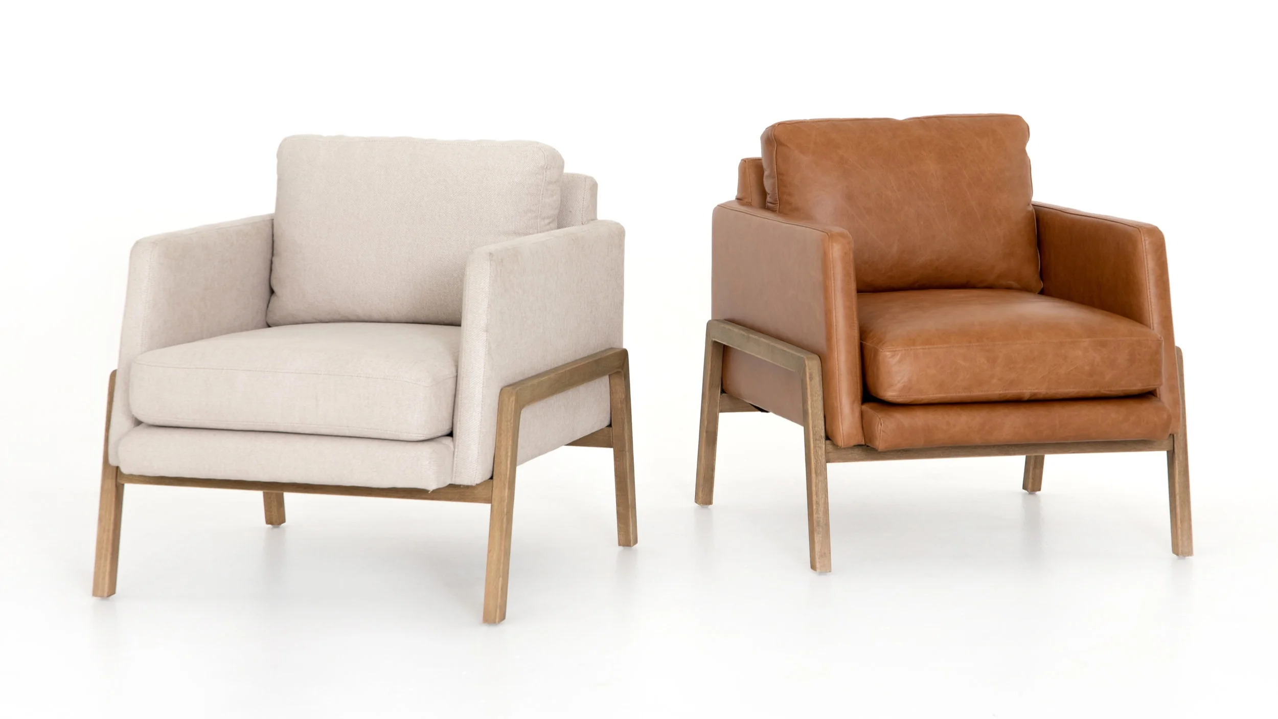 Diana Chair | Effortlessly cool. Available in butterscotch top-grain leather and ivory performance-grade fabric, angular track arms complement supple cushioning, with exposed parawood framing delivering the drama.