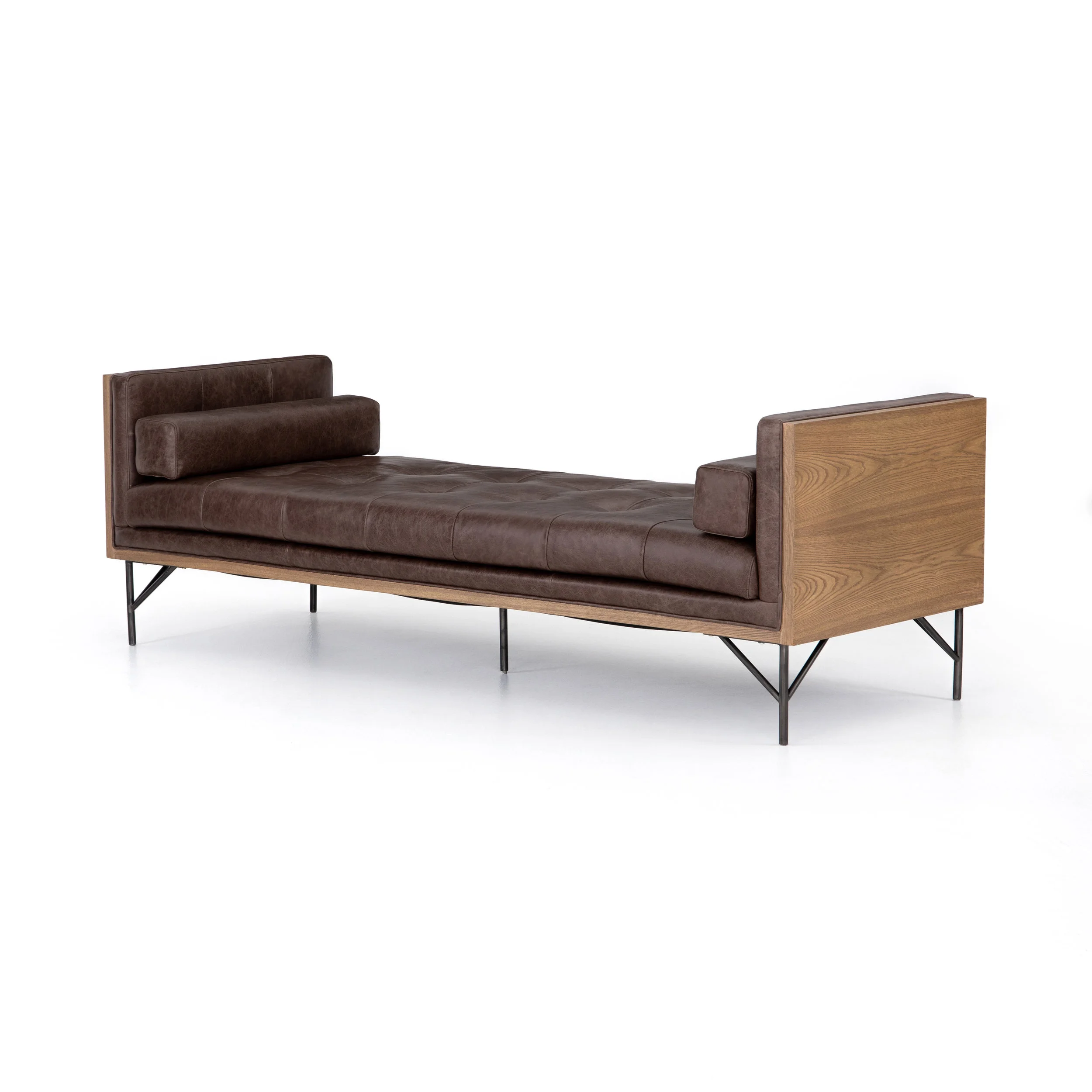 Holden Chaise | Mid-century swank modernized by mixed materials. Toasted ash casing contains exclusive top-grain leather, cocoa in color and lightly tufted for comfort. Oxidized iron legs and lumbar pillows for a forward-thinking finishing touch. Also available in Cream Upholstery.